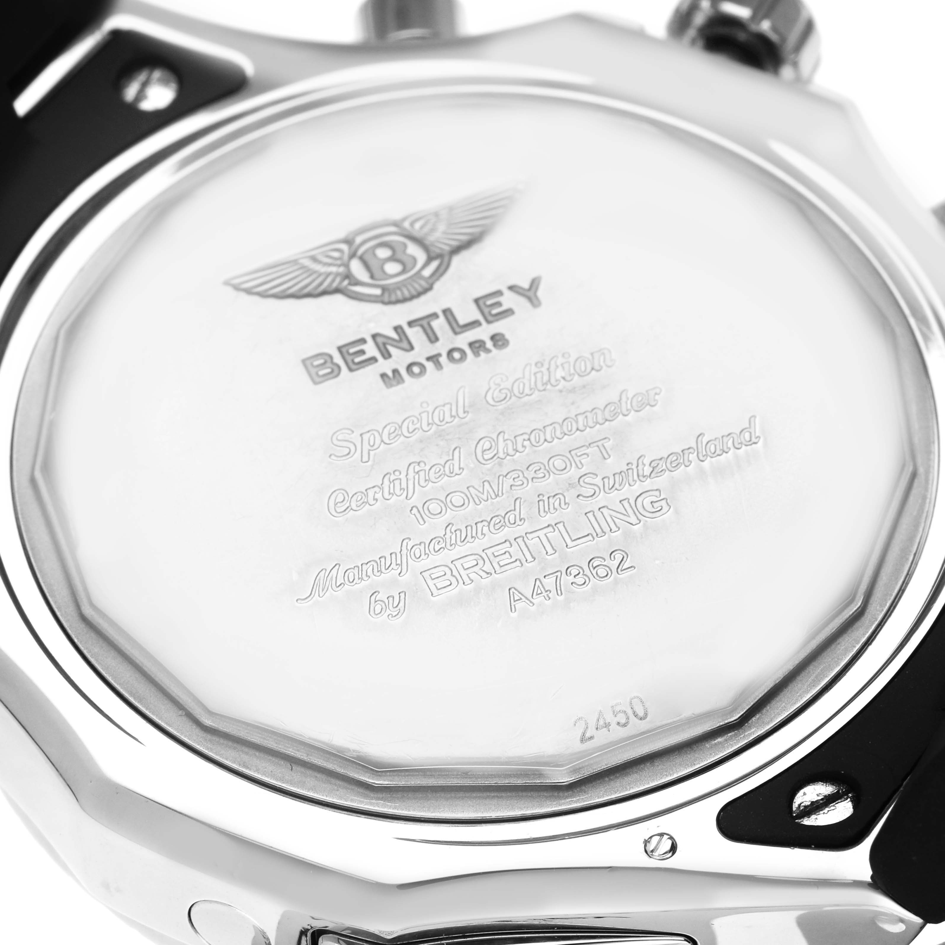 The image shows the back of a Bentley model by Breitling, highlighting the engraved details and surrounding metal parts.