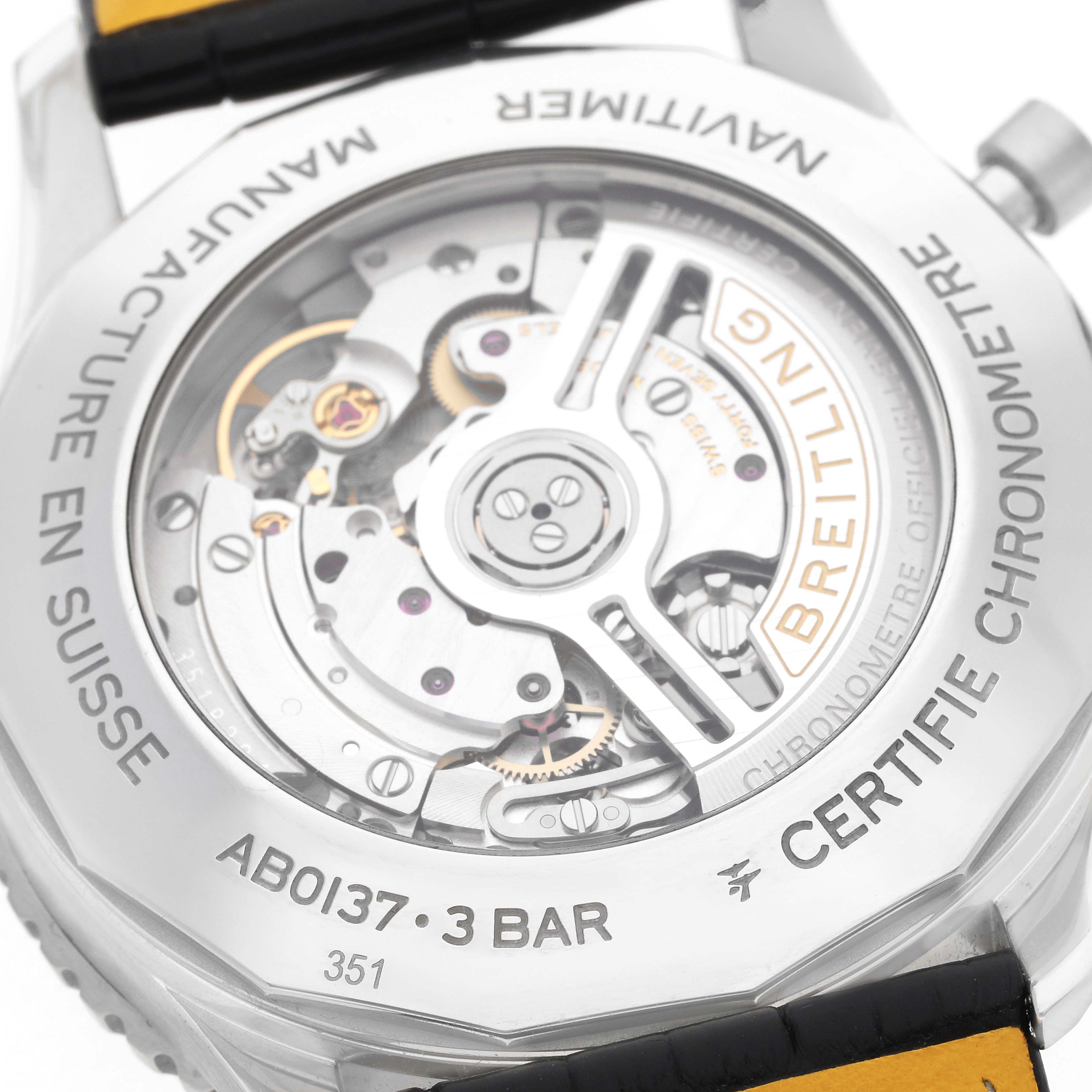 The image shows the back of a Breitling Navitimer AB0137 Men
s Stainless Steel Green Dial watch, highlighting the visible mechanical movement and engraved details.