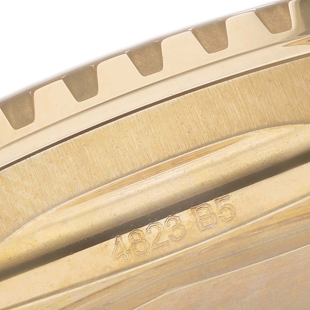 The image shows a close-up of the bezel and case edge of a Breitling Superocean N17375 Men
s Bronze Green Dial watch, featuring its textured detail and engravings.
