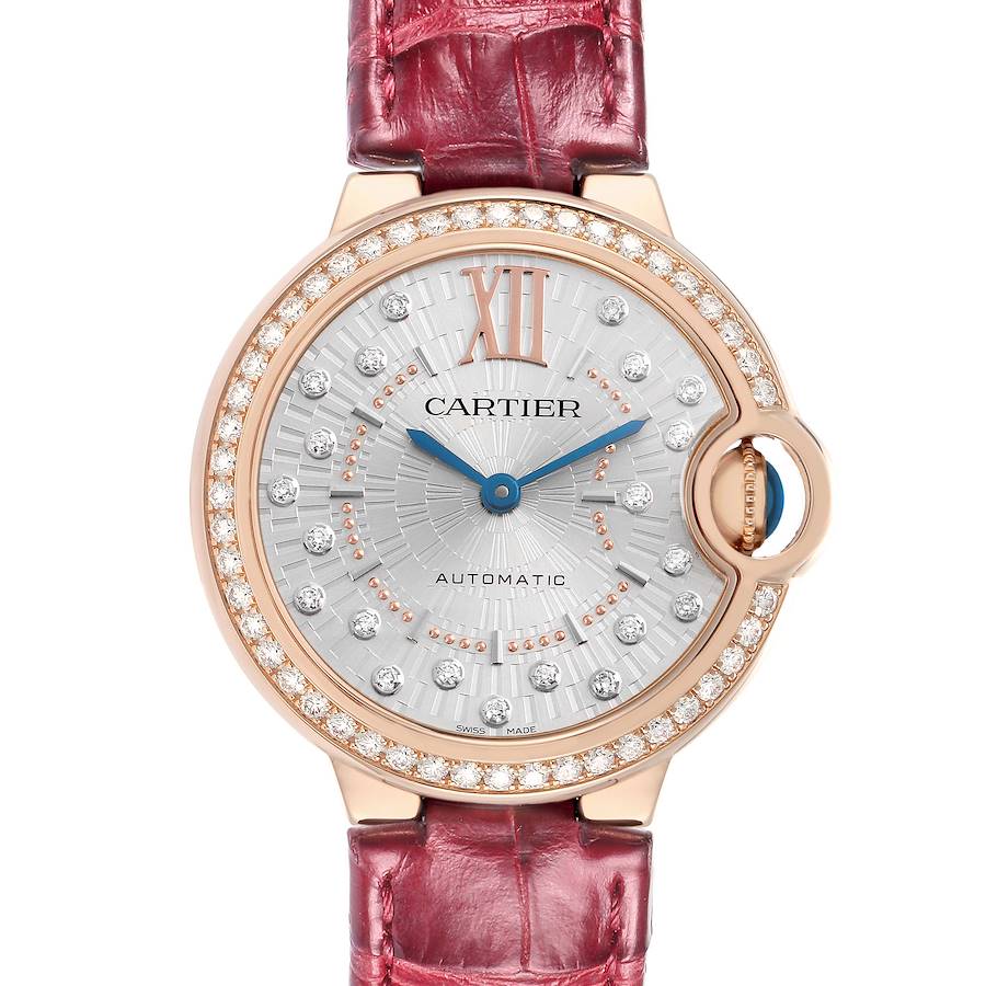 The Cartier Ballon Bleu WJBB0080 Women's Rose Gold Silver Dial watch is shown from the front, highlighting its diamond-adorned bezel and silver dial, with a red strap.