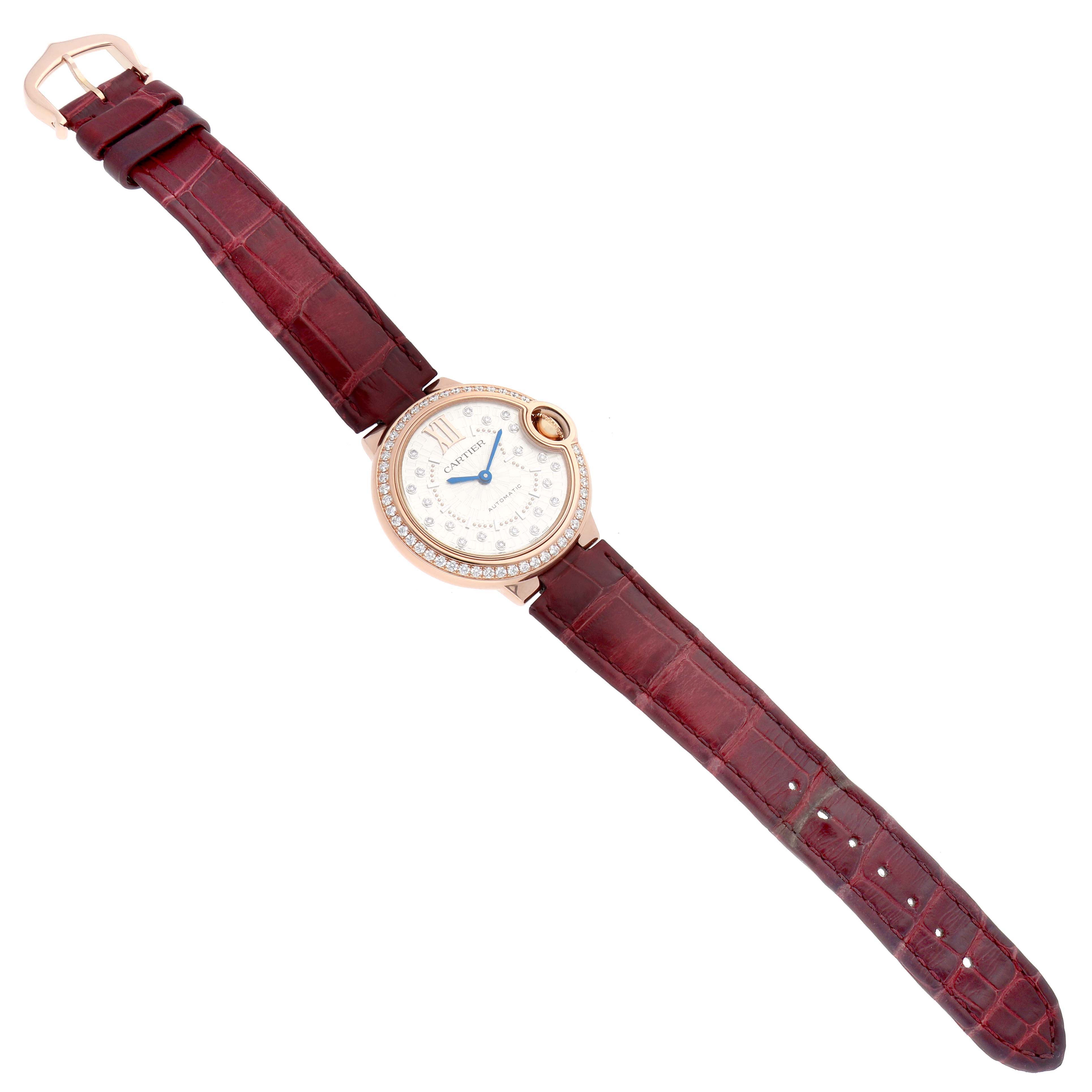 The Cartier Ballon Bleu WJBB0080 Women
s Rose Gold Silver Dial watch is shown from a top-down angle, displaying the entire face and strap.