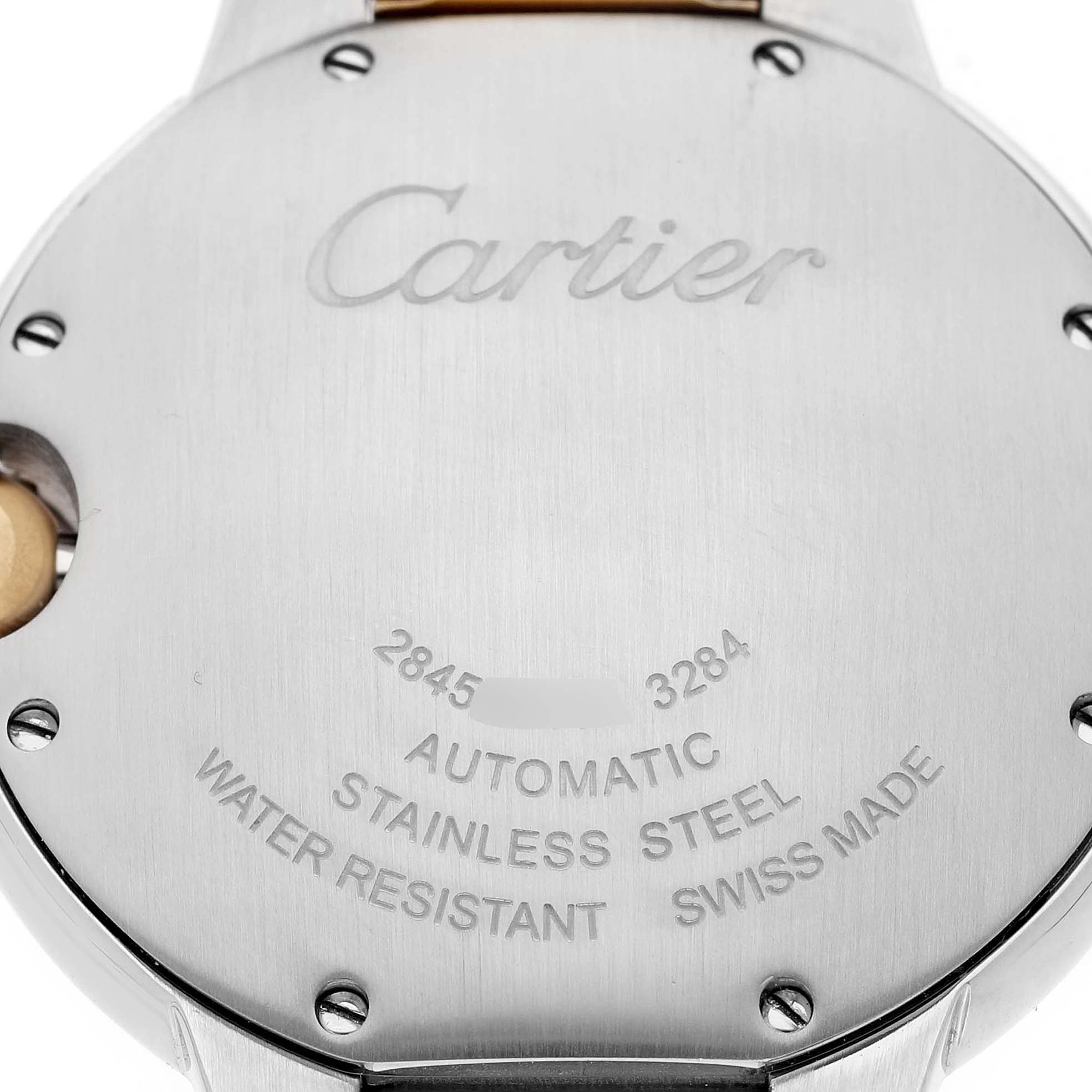 The image shows the back of a Ballon Bleu de Cartier watch, featuring engravings and screws on the stainless steel case.