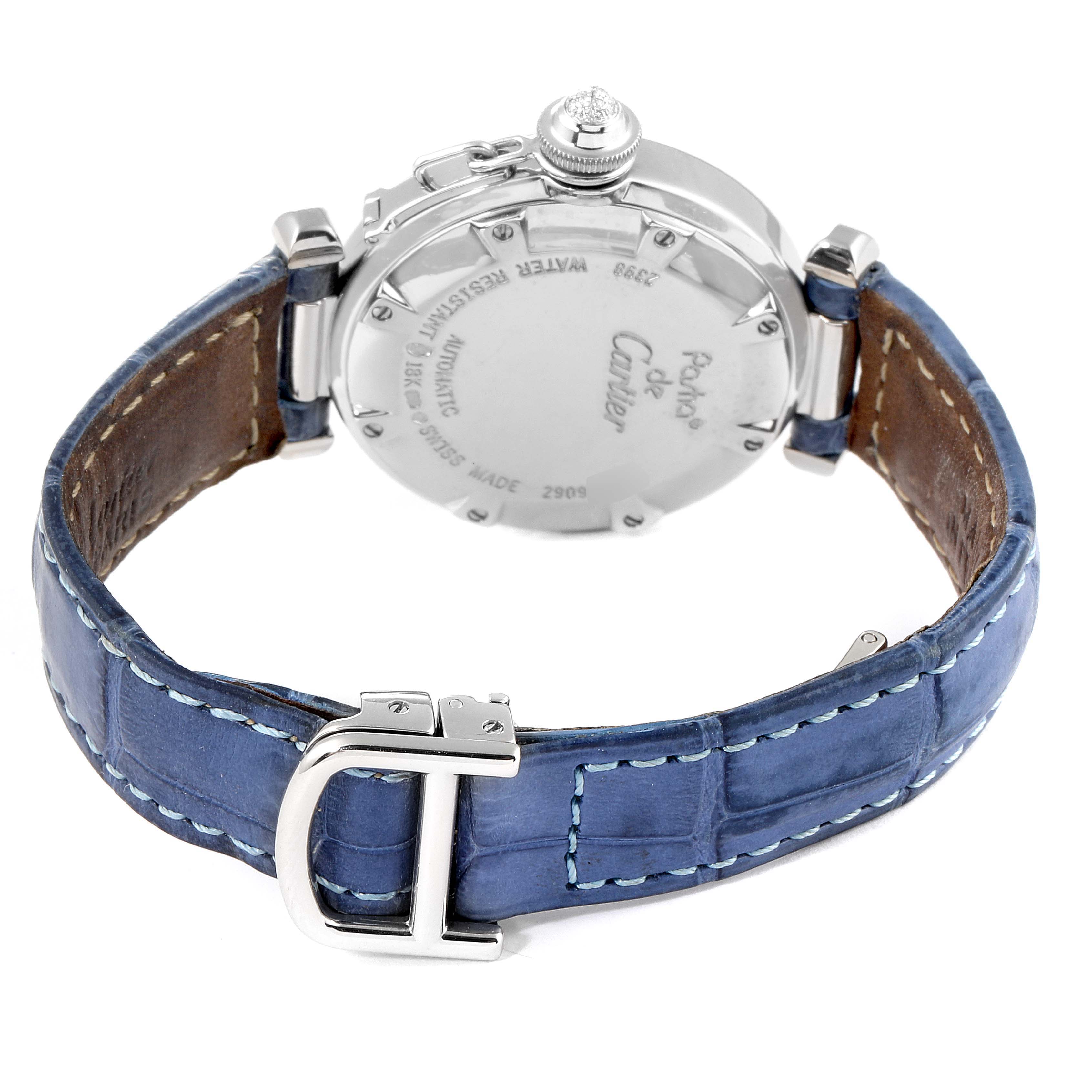 The image shows the backside of a Cartier Pasha WJ111651 Women's Stainless Steel Silver Dial WJ111651 Women's Stainless Steel Silver Dial watch, highlighting its case back and blue leather strap with a silver buckle.