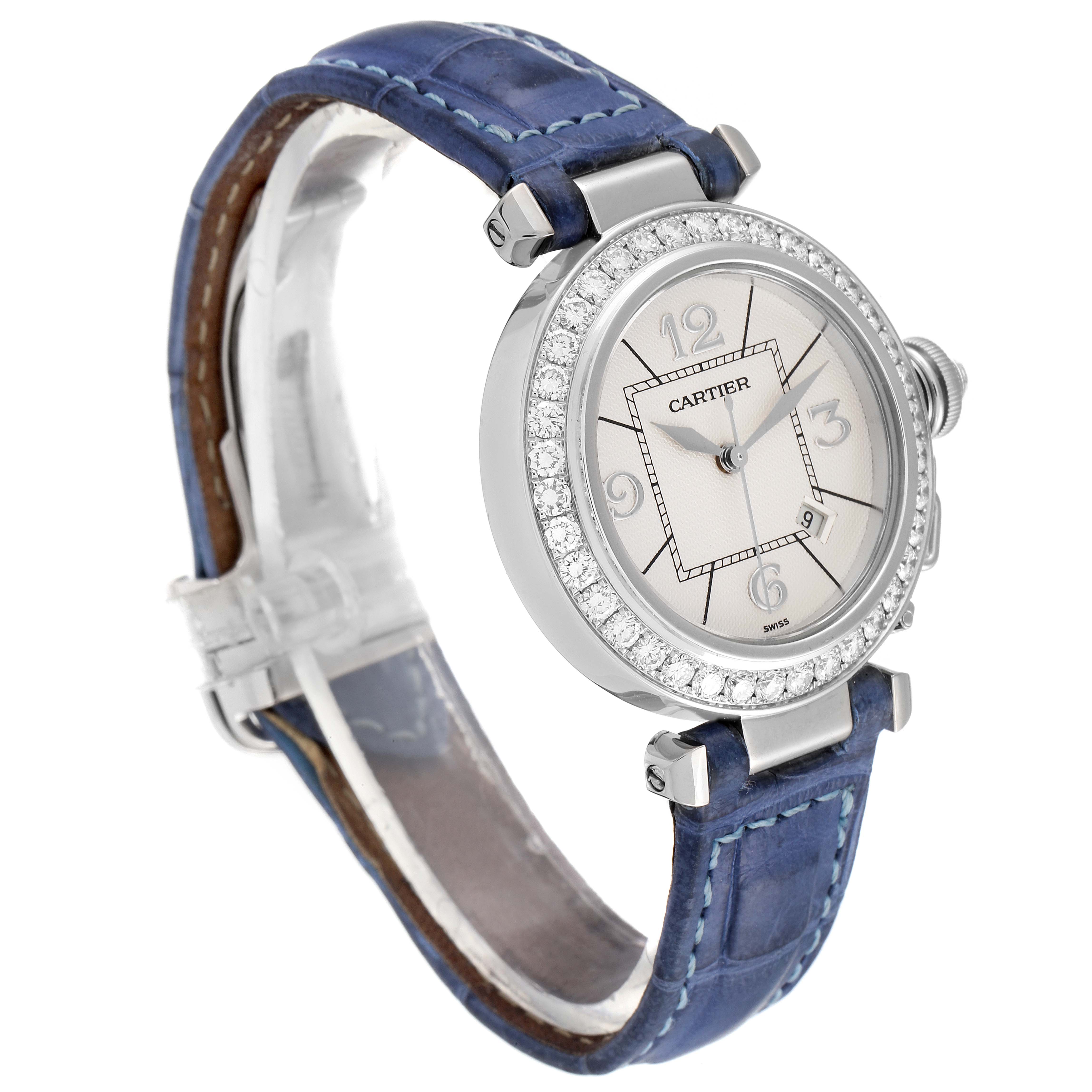 The image shows a Cartier Pasha WJ111651 Women's Stainless Steel Silver Dial WJ111651 Women's Stainless Steel Silver Dial watch with a blue leather strap, diamond bezel, and silver dial, viewed from a three-quarter angle.