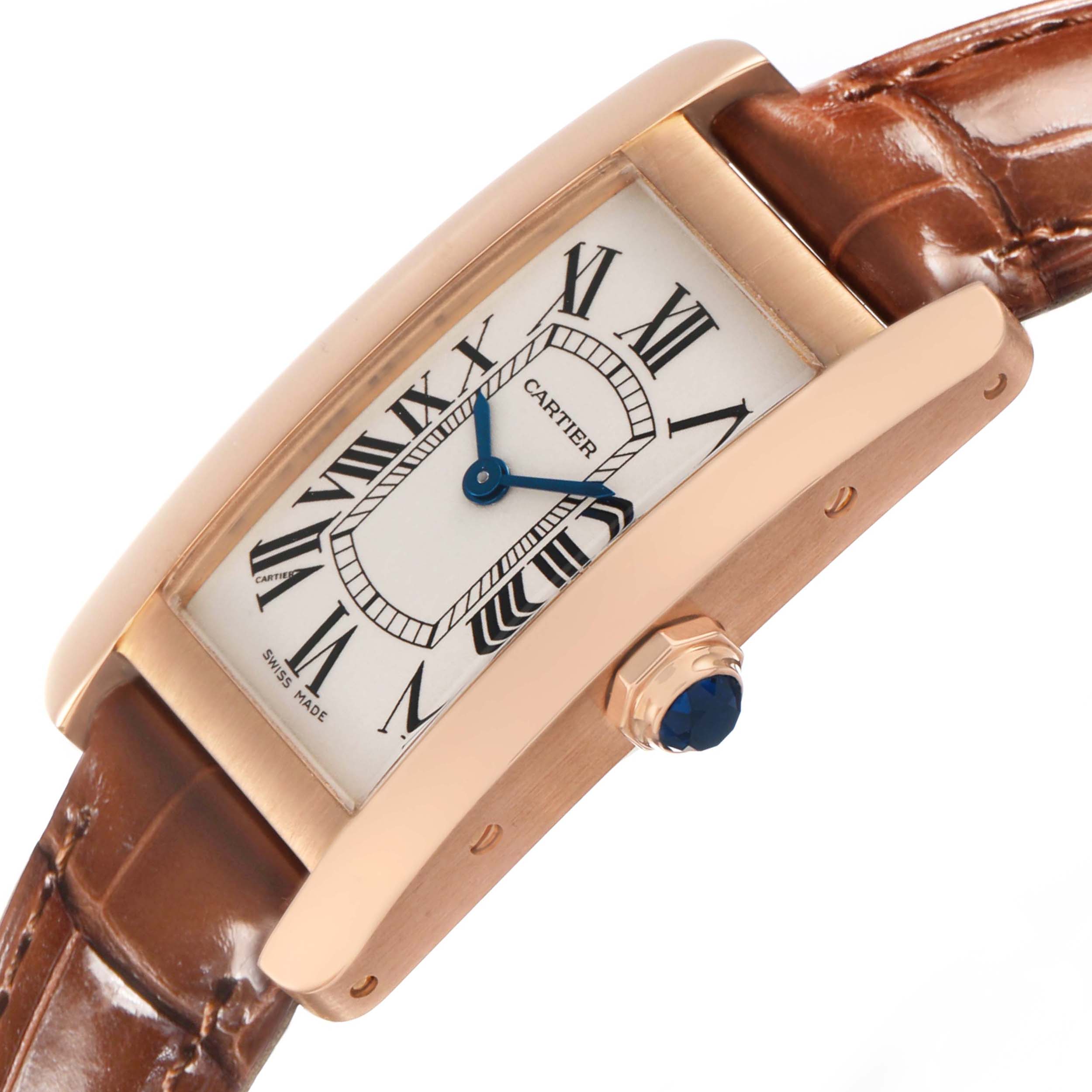 The Cartier Tank Américaine watch is shown at an angle highlighting the case, dial, crown, and part of the leather strap.