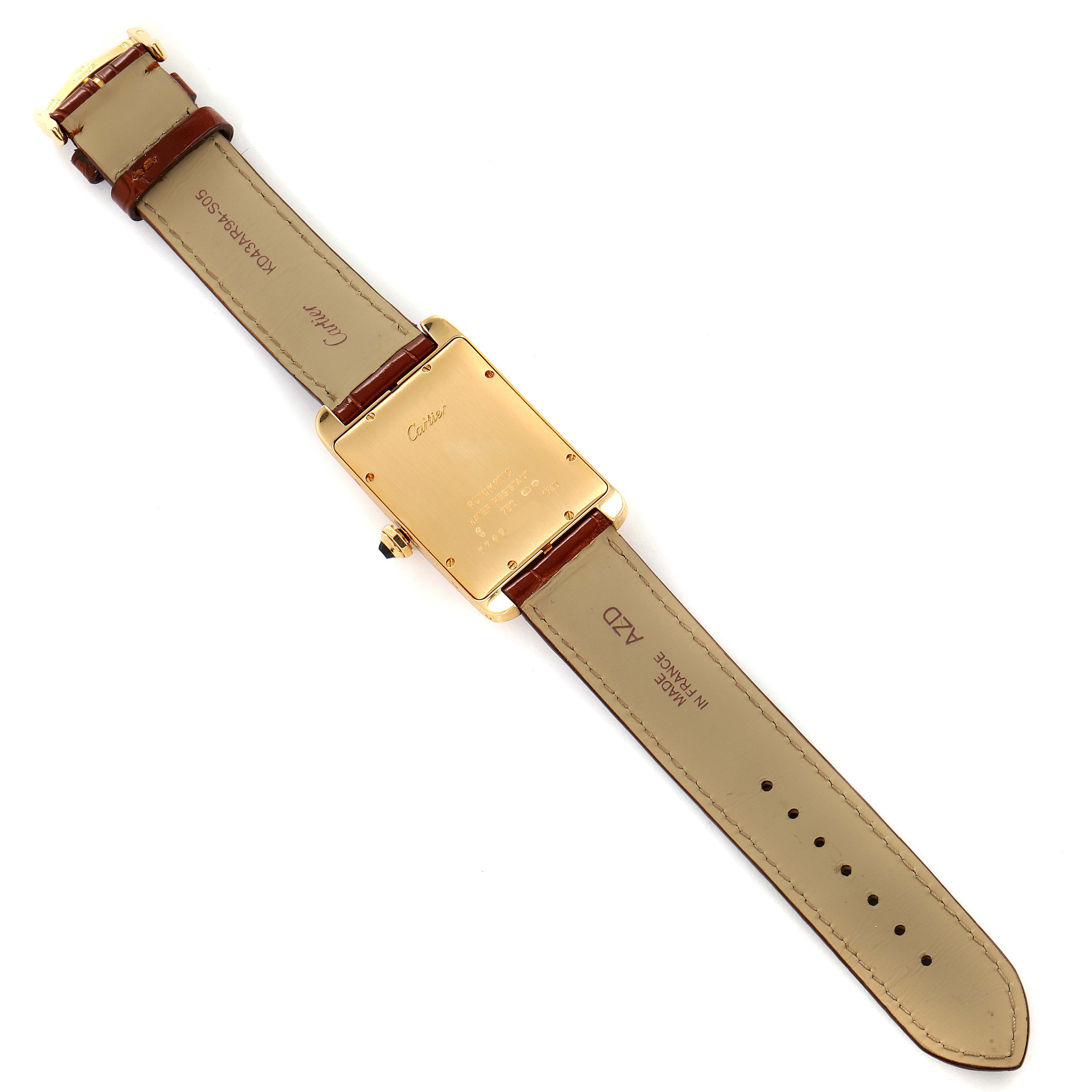 The image shows the back view of a Cartier Tank Americaine W2603156 Men
s Yellow Gold Silver Dial W2603156 Men
s Yellow Gold Silver Dial watch, highlighting the case back and leather strap.