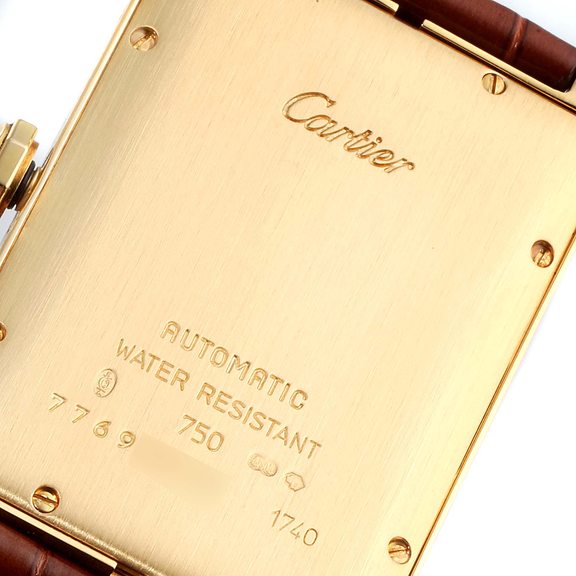 This image shows the back of a Tank Americaine watch by Cartier, highlighting its engraved details.
