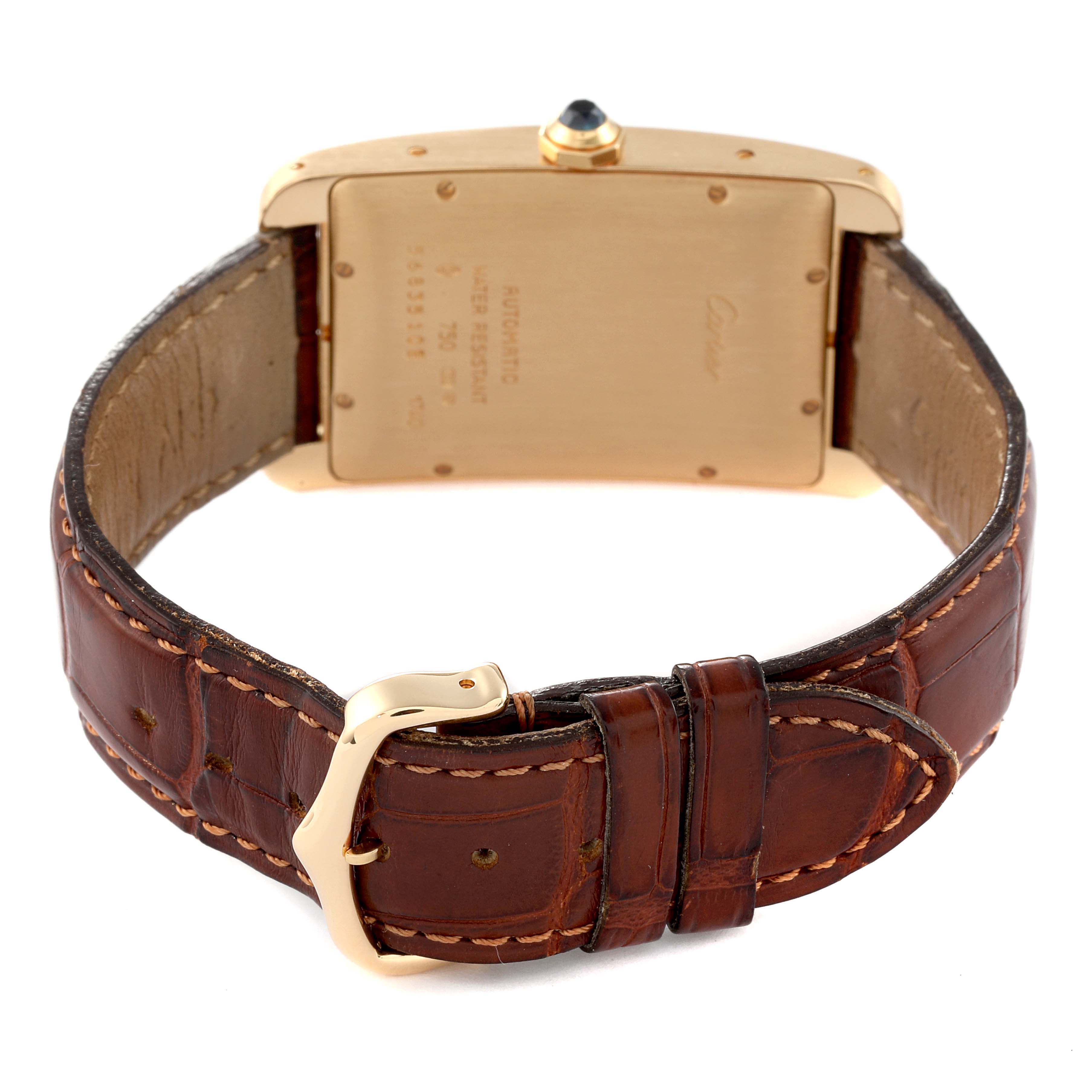The image shows the back view of a Cartier Tank Américaine watch, highlighting its case back, crown, and leather strap with clasp.