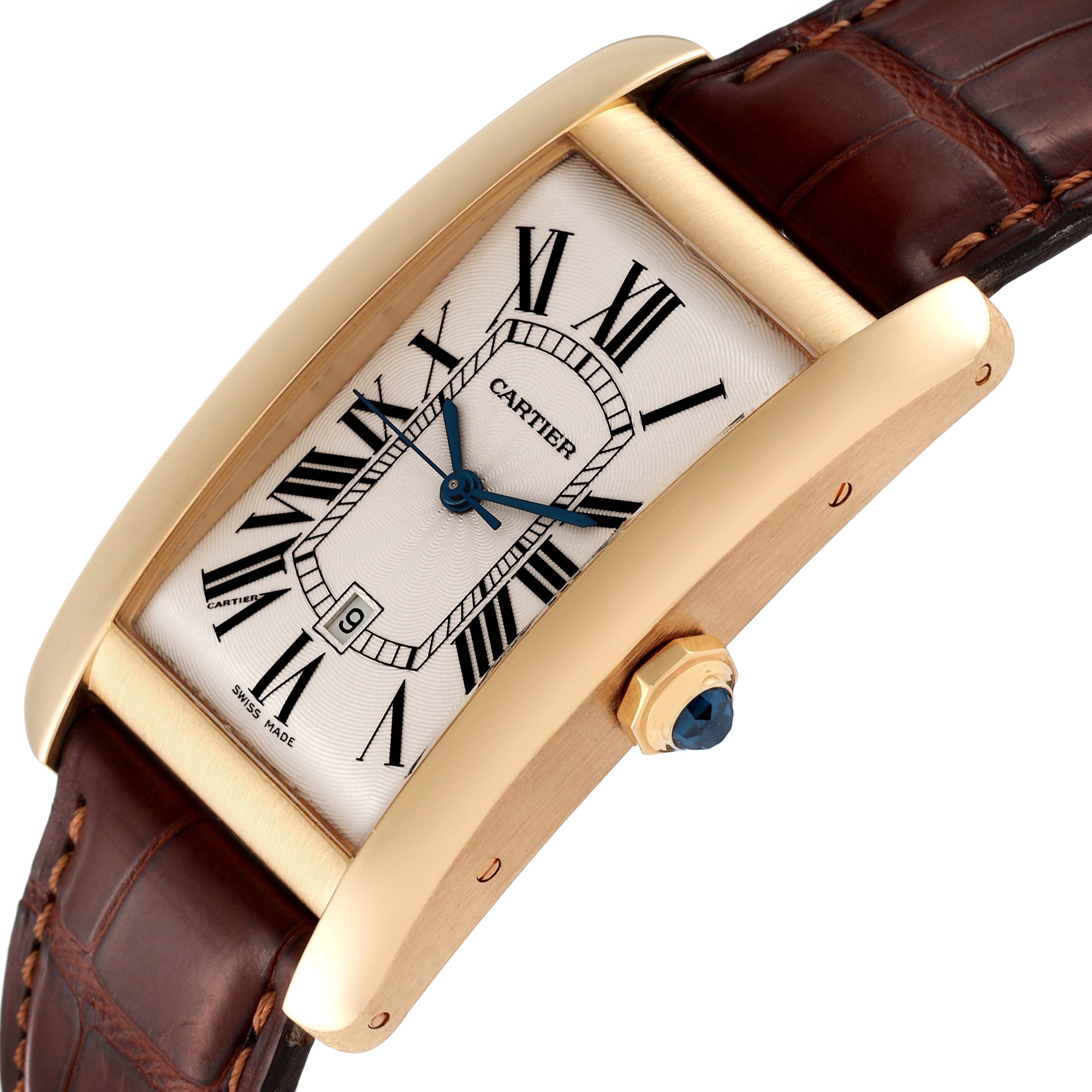 The image shows a close-up of the Cartier Tank Americaine W2603156 Men's Yellow Gold Silver Dial W2603156 Men's Yellow Gold Silver Dial watch from a three-quarter side angle, highlighting the face, crown, and strap.