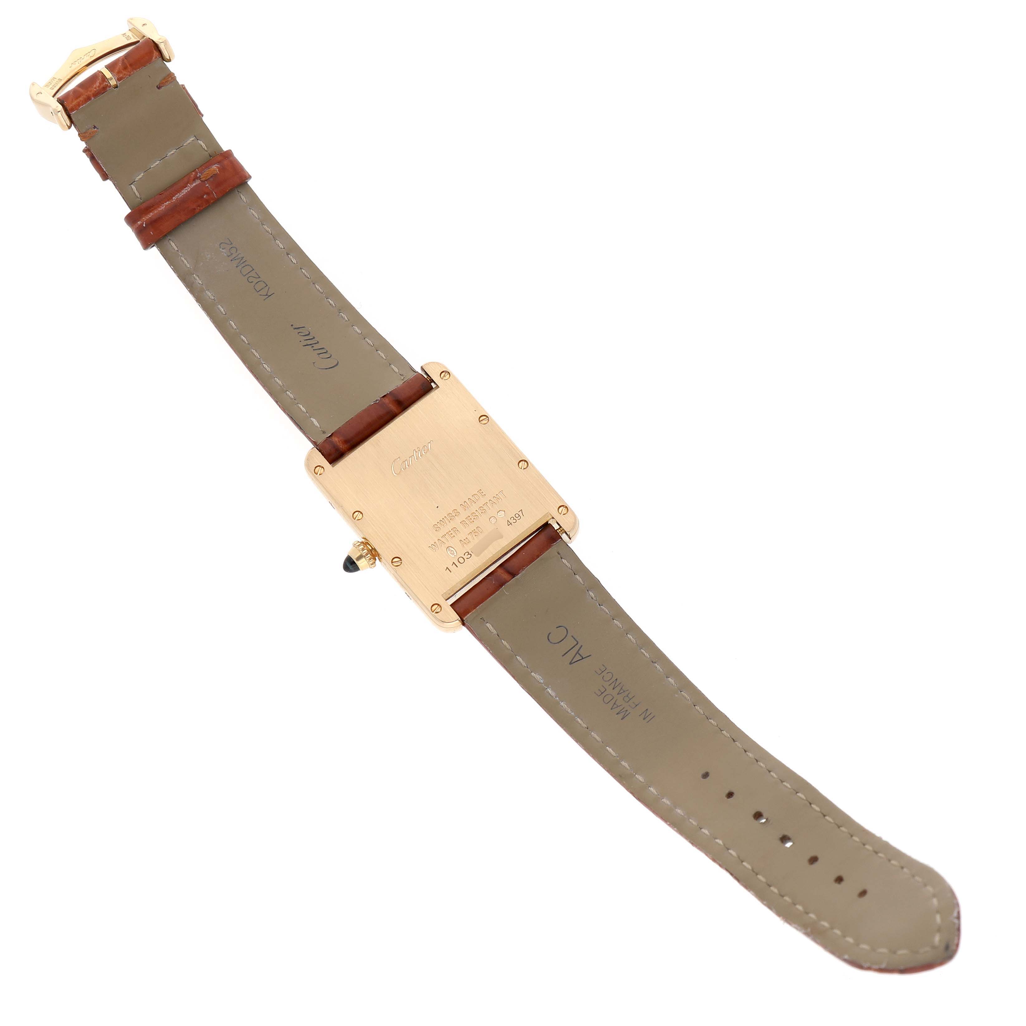 The image shows the underside of a Cartier Tank Louis WGTA0067 Men's Yellow Gold Silver Dial watch, highlighting the case back and leather strap.