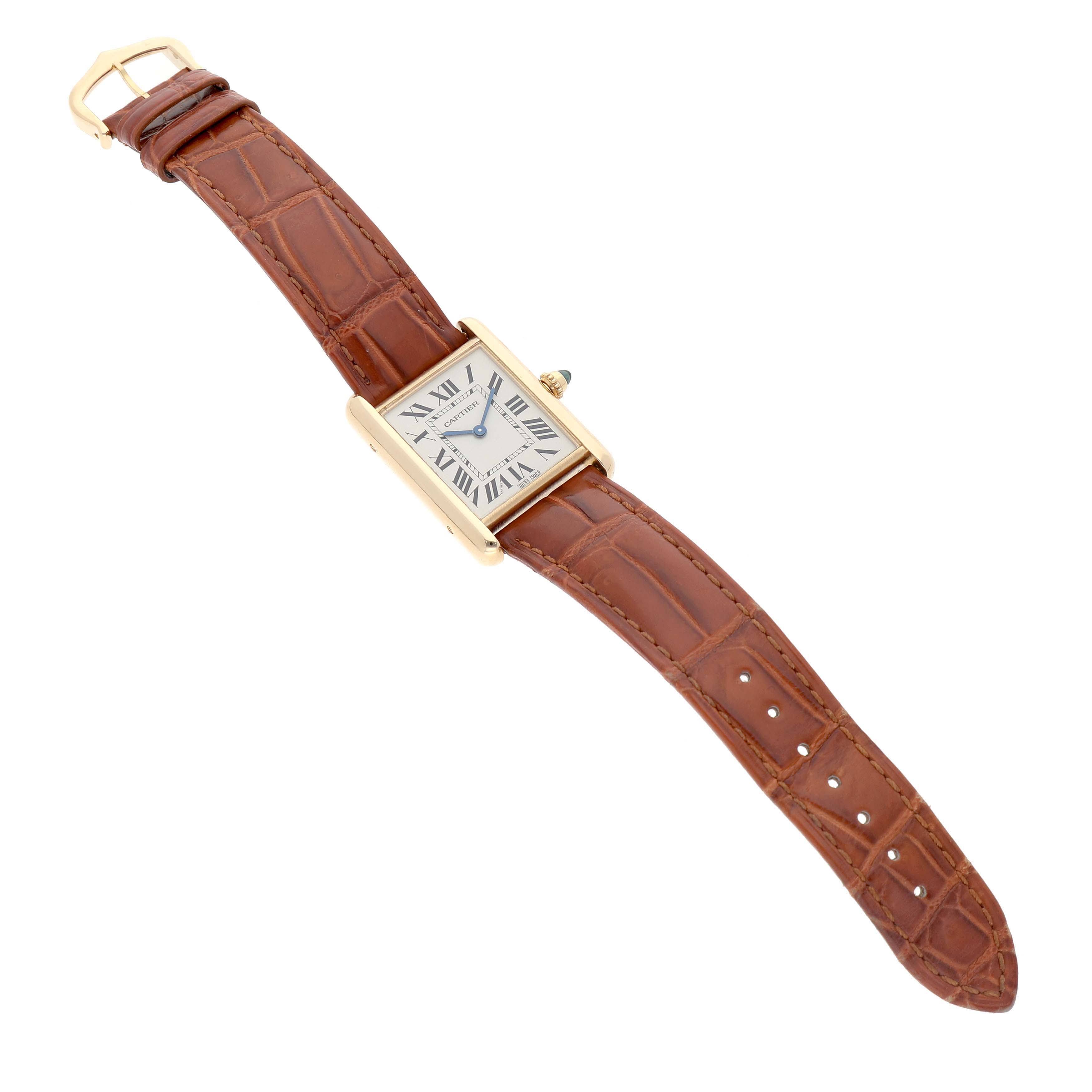 The Cartier Tank Louis WGTA0067 Men's Yellow Gold Silver Dial watch is shown at an angle highlighting its rectangular face, brown leather strap, and gold buckle.