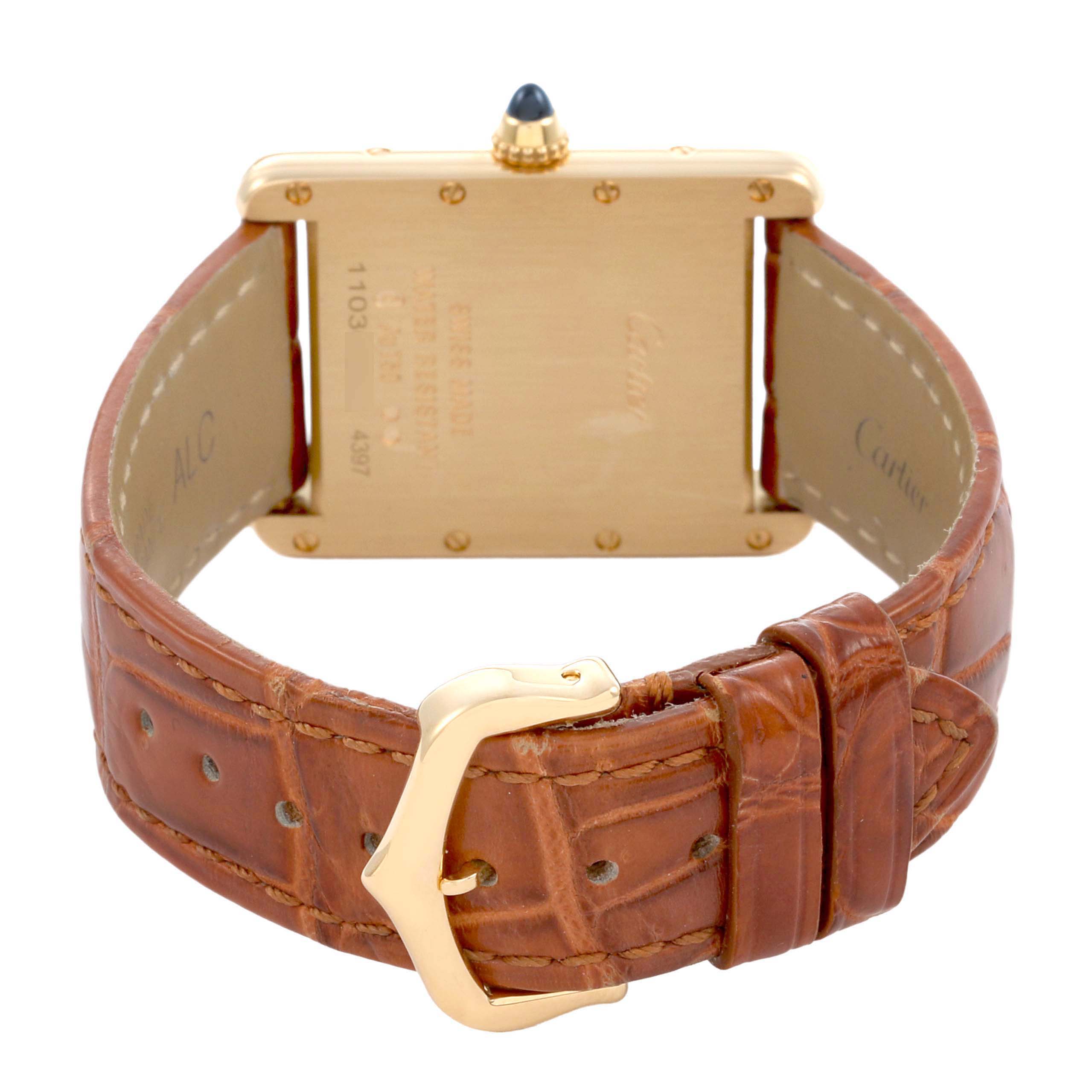 The Cartier Tank Louis WGTA0067 Men's Yellow Gold Silver Dial watch is shown from the back, highlighting its case, brown leather strap, and buckle.
