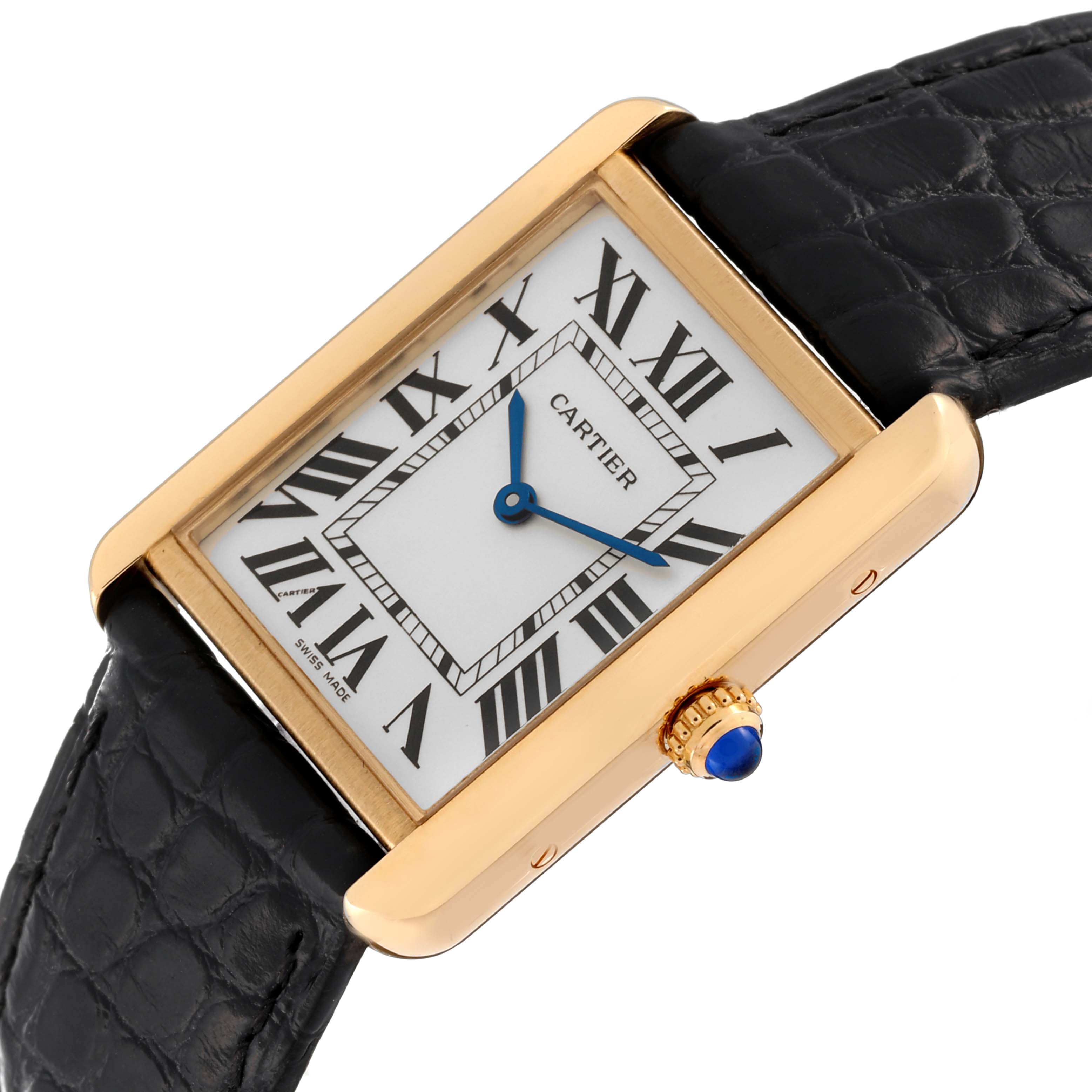 This Cartier Tank Solo W5200004 Men's Yellow Gold Silver Dial W5200004 Men's Yellow Gold Silver Dial watch is shown at an angle, highlighting its gold case, white dial with Roman numerals, blue hands, and black leather strap.