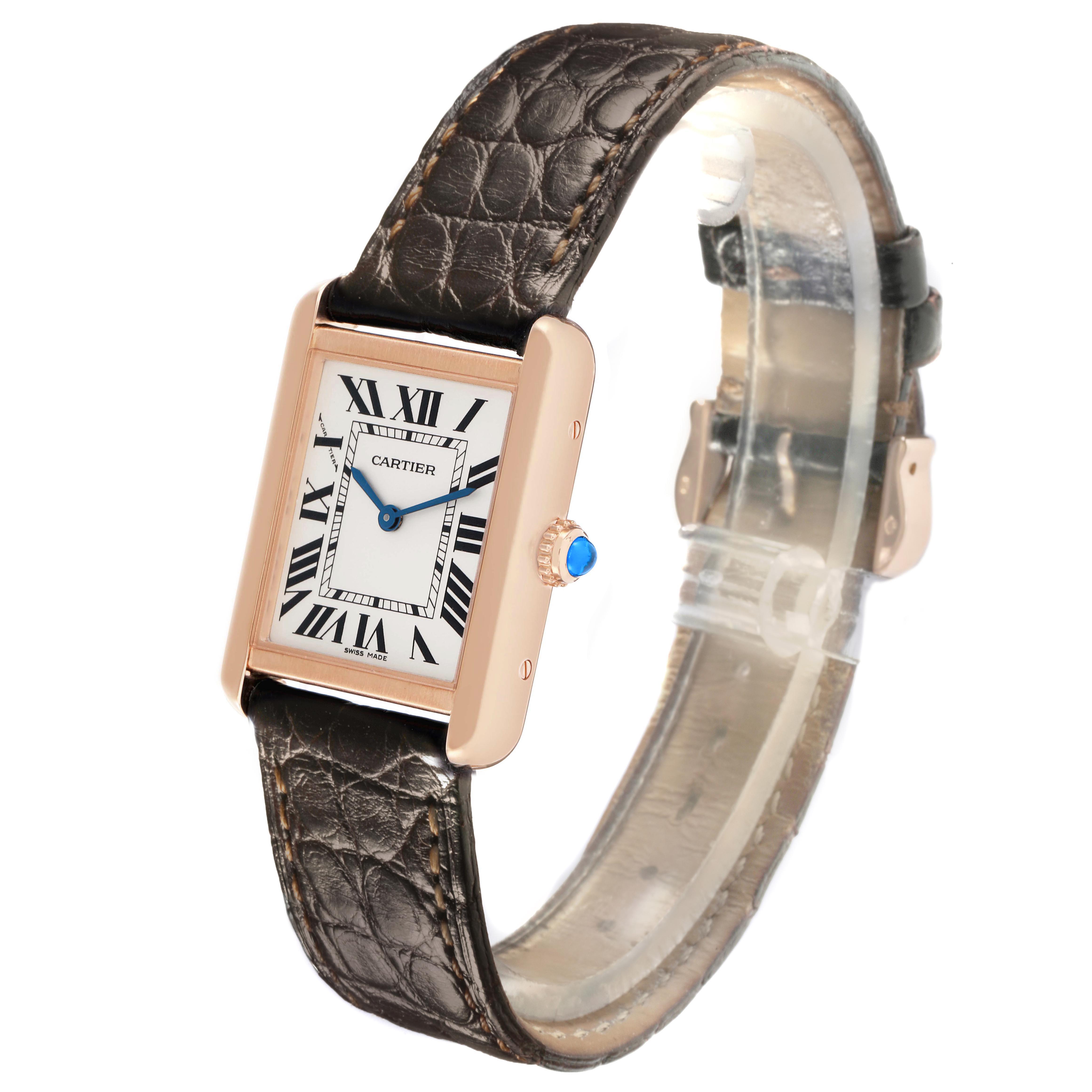 The Cartier Tank Solo W5200024 Women's Rose Gold Silver Dial watch is shown at an angled view, displaying its rectangular face, Roman numerals, crown, and leather strap.