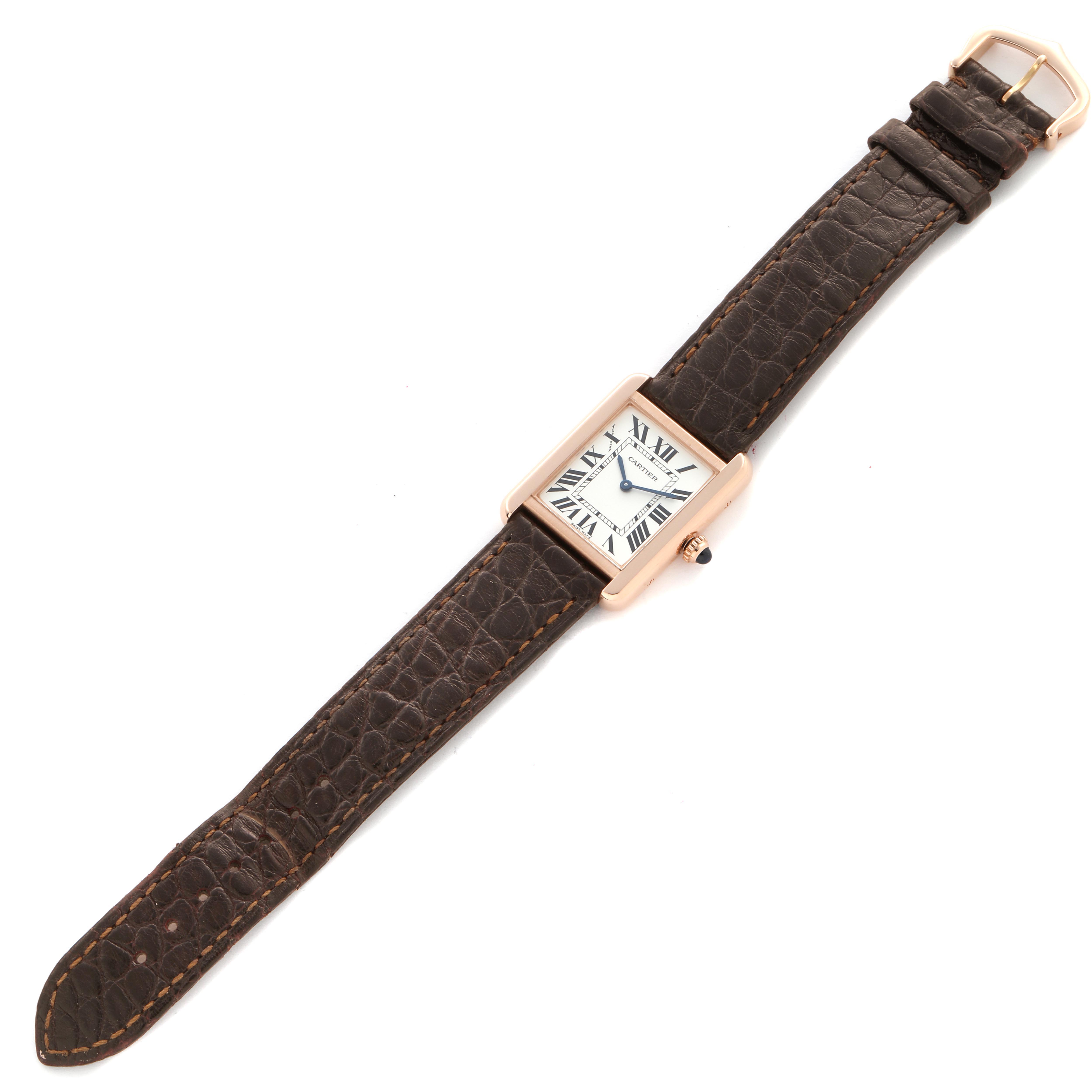 The Cartier Tank Solo W5200024 Women's Rose Gold Silver Dial watch is shown from a top-down angle, featuring its rectangular face and brown leather strap.