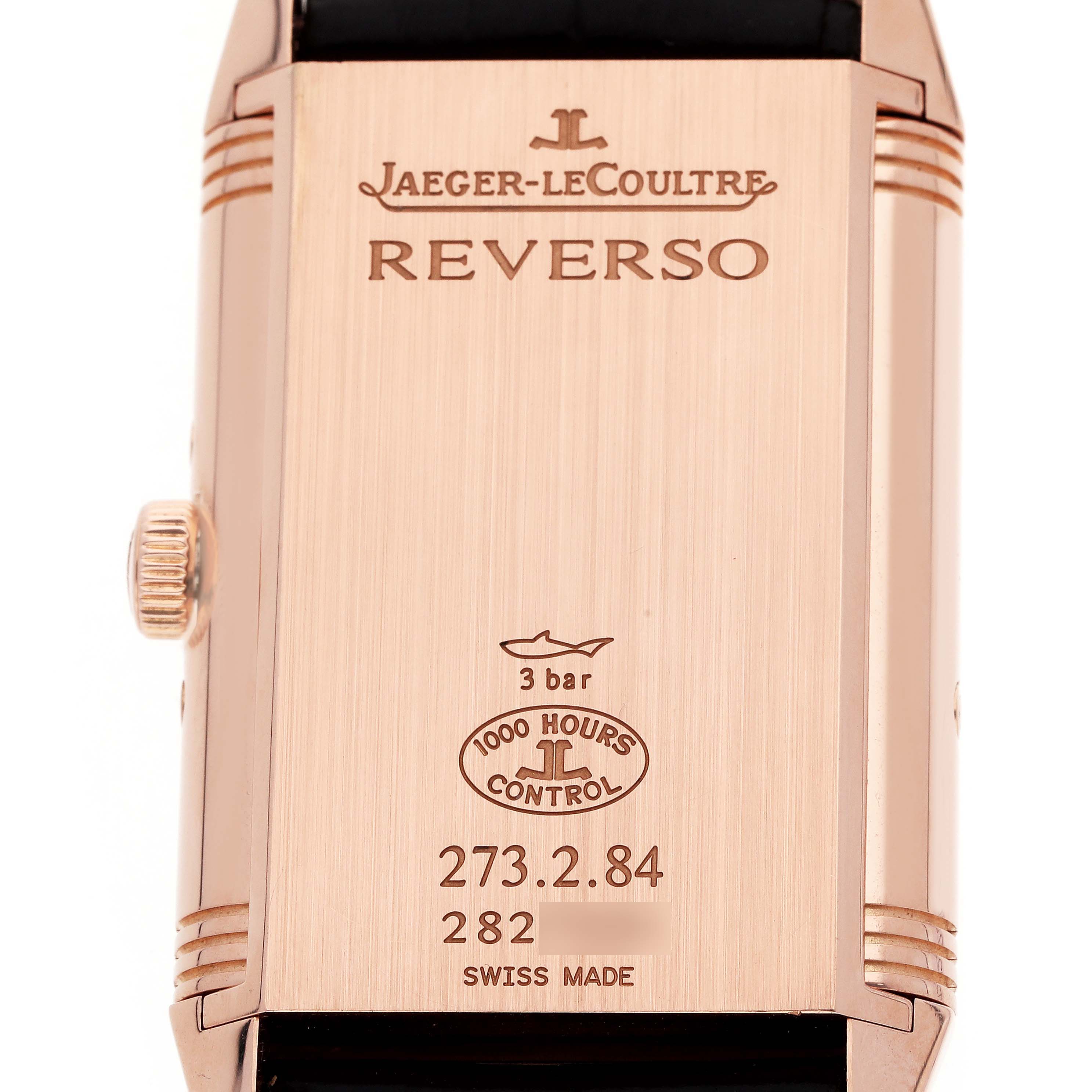 The image shows the back of a Jaeger-LeCoultre Reverso watch at a straight-on angle, displaying the case details and side crown.
