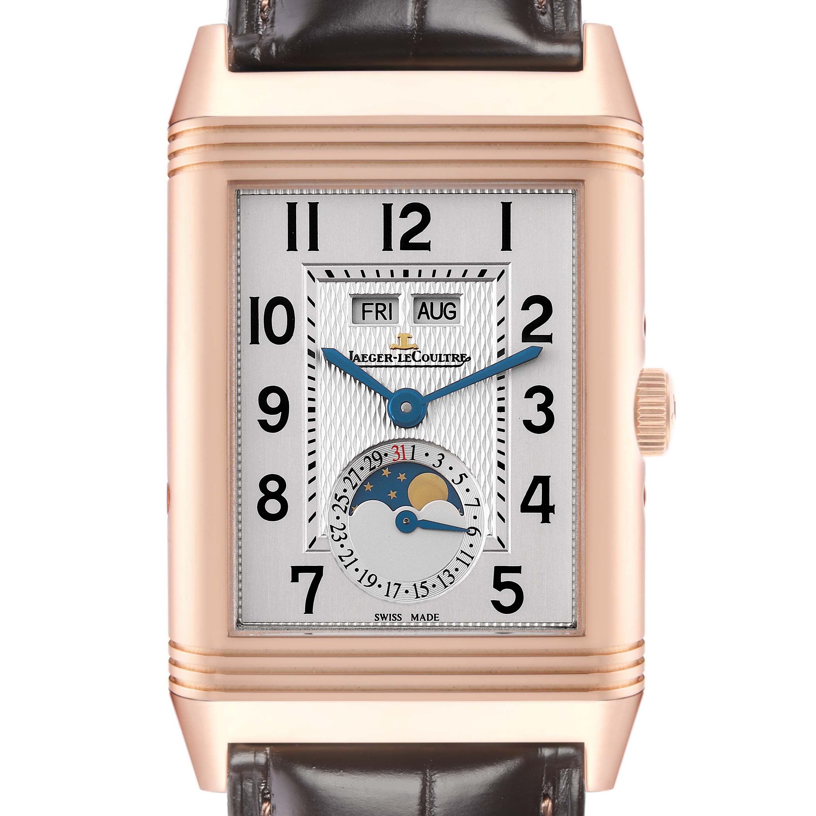 The Jaeger-LeCoultre Reverso watch is shown from the front, displaying the face, numerals, day-date, and moon phase.