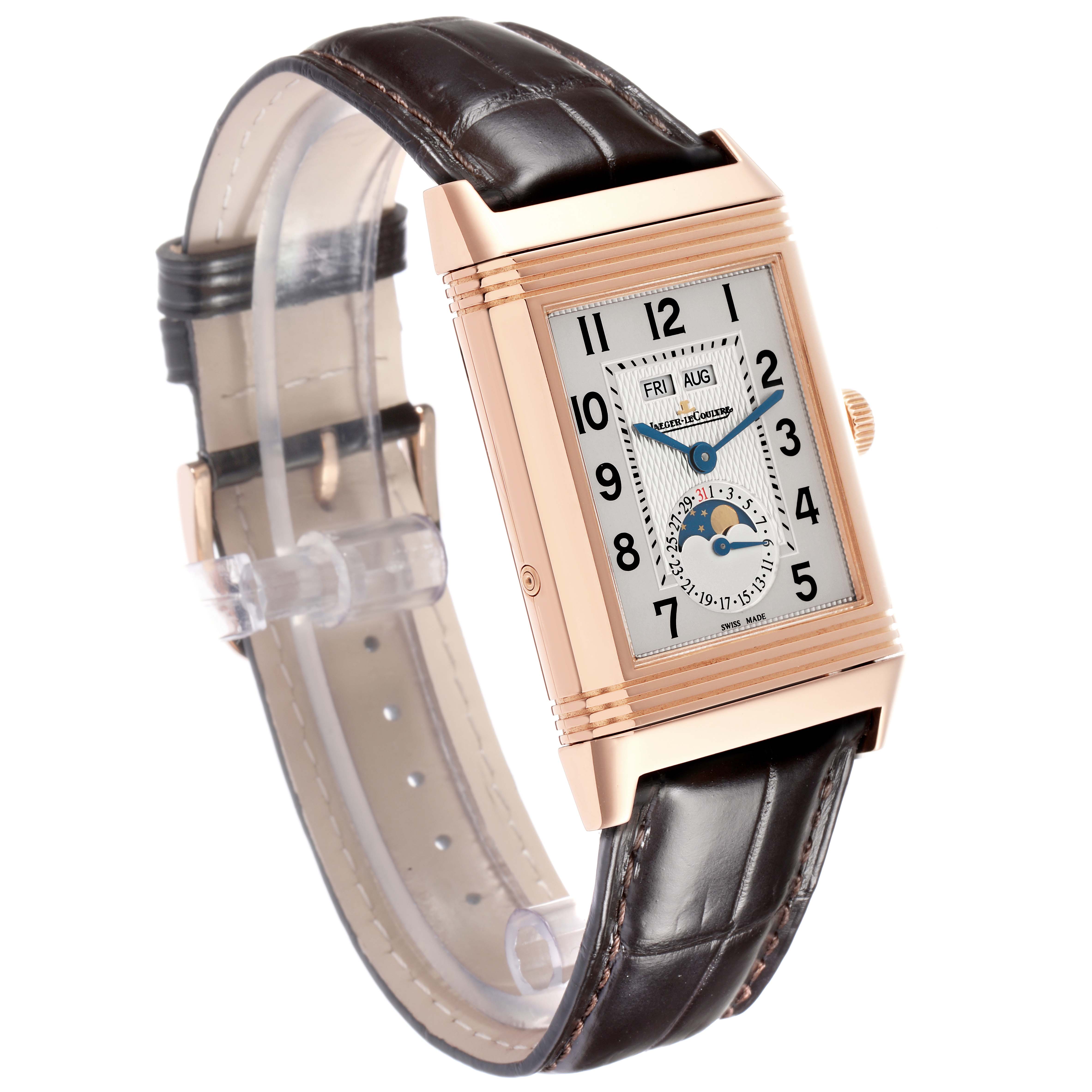 The Jaeger-LeCoultre Reverso watch is shown at a three-quarter angle, highlighting the face, rectangular case, and leather strap.