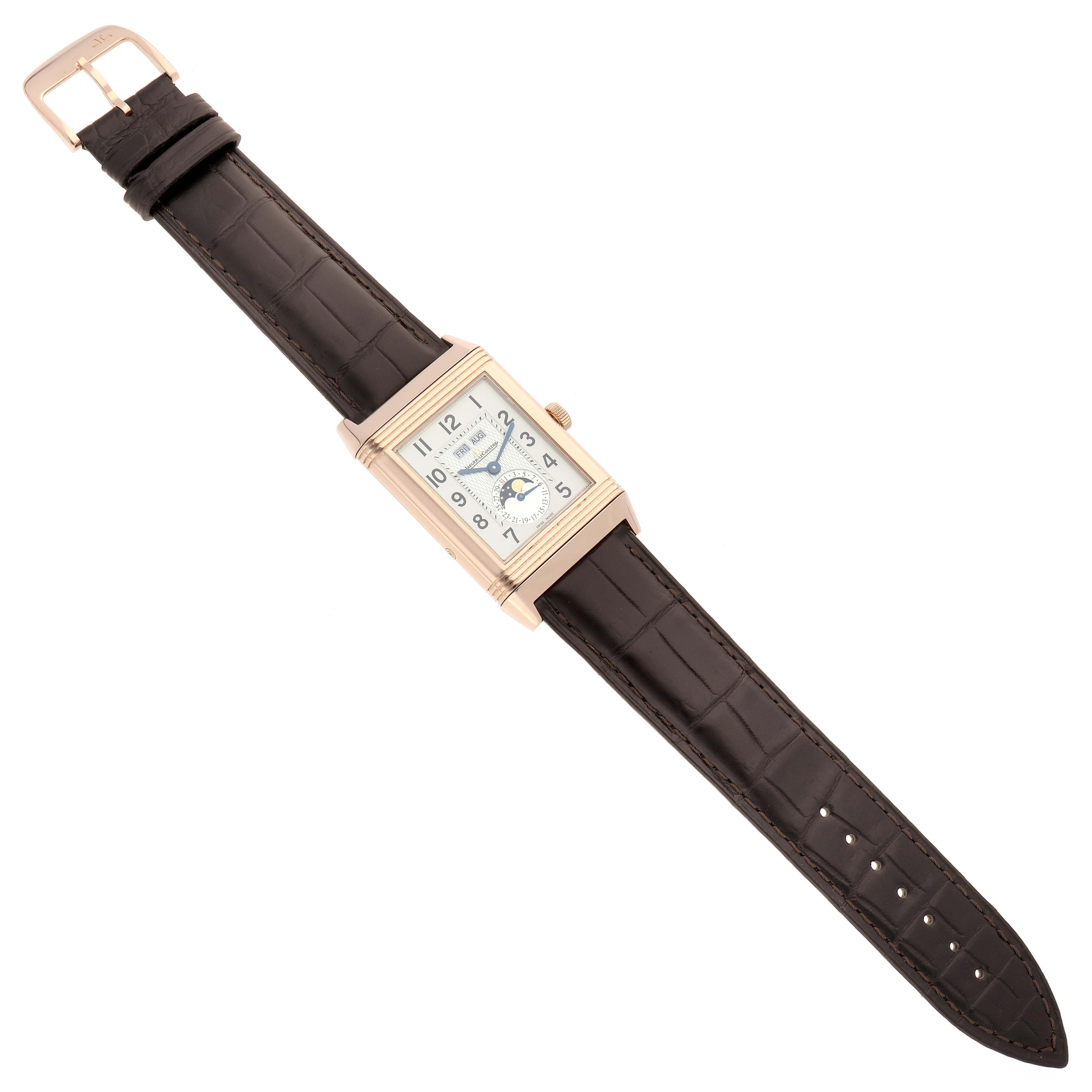 The Jaeger-LeCoultre Reverso watch is shown from the top, displaying the face, case, and leather strap.