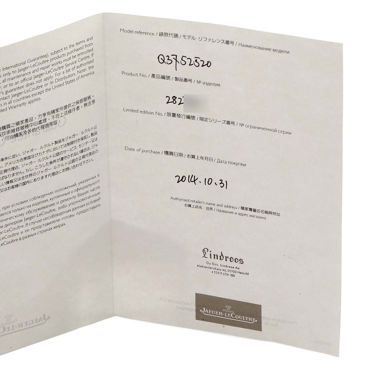 The image shows an open warranty card for a Jaeger-LeCoultre Reverso, revealing model and purchase details.