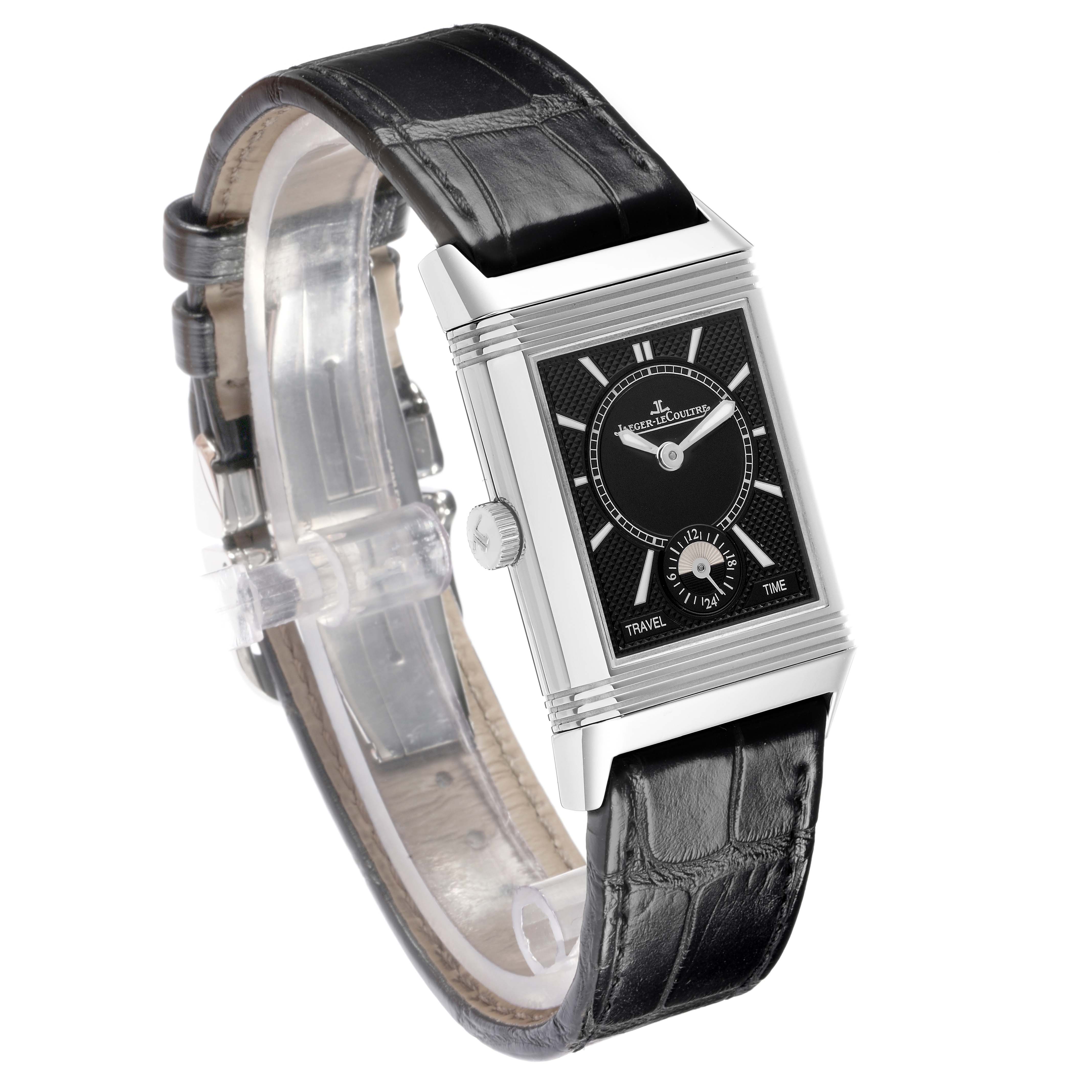The Jaeger-LeCoultre Reverso watch is shown at a tilted angle, highlighting its rectangular face, crown, and black leather strap.