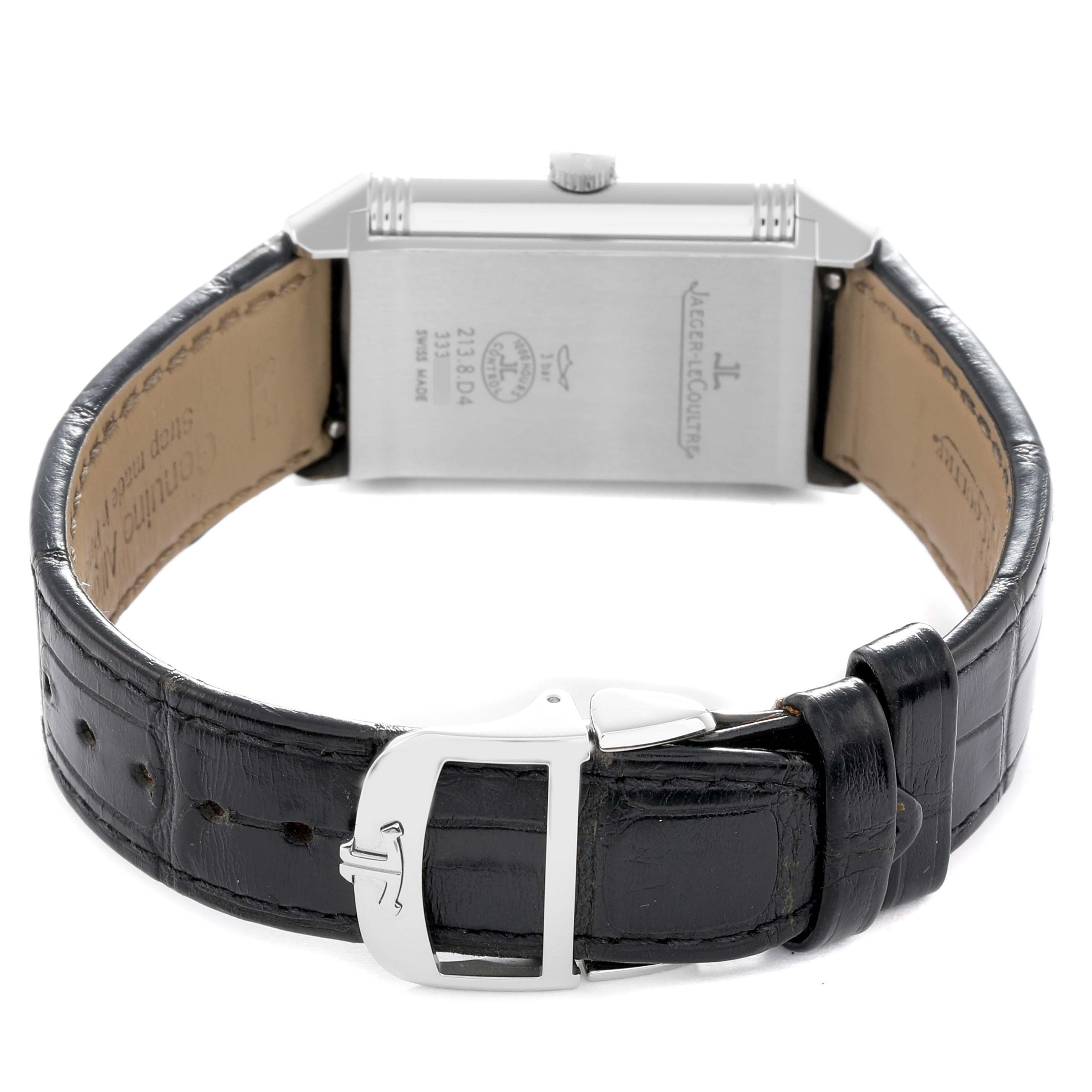 The image shows the back of the Jaeger-LeCoultre Reverso watch, displaying its case back, crown, and leather strap with buckle.