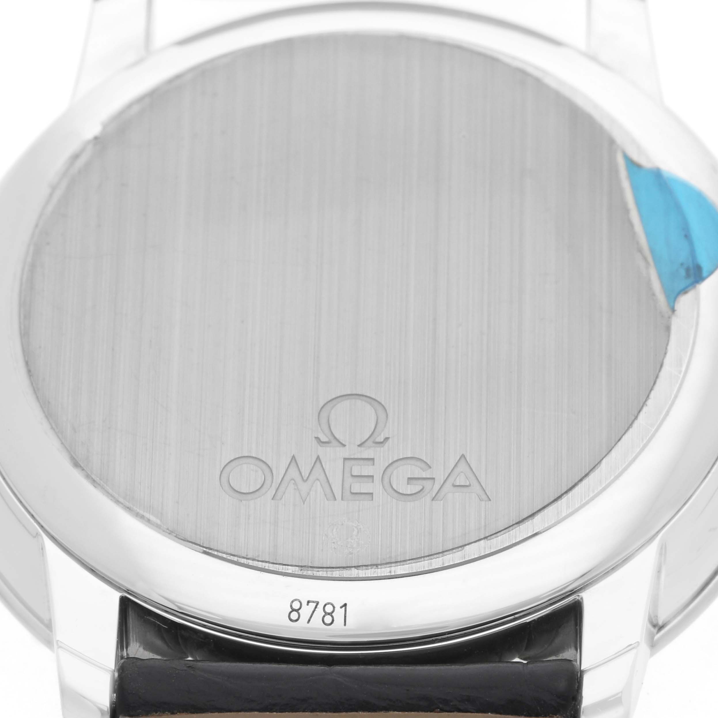 The image shows the back of an Omega De Ville 424.13.40.20.01.001 Men
s Stainless Steel Black Dial watch, highlighting the case back and a part of the leather strap.