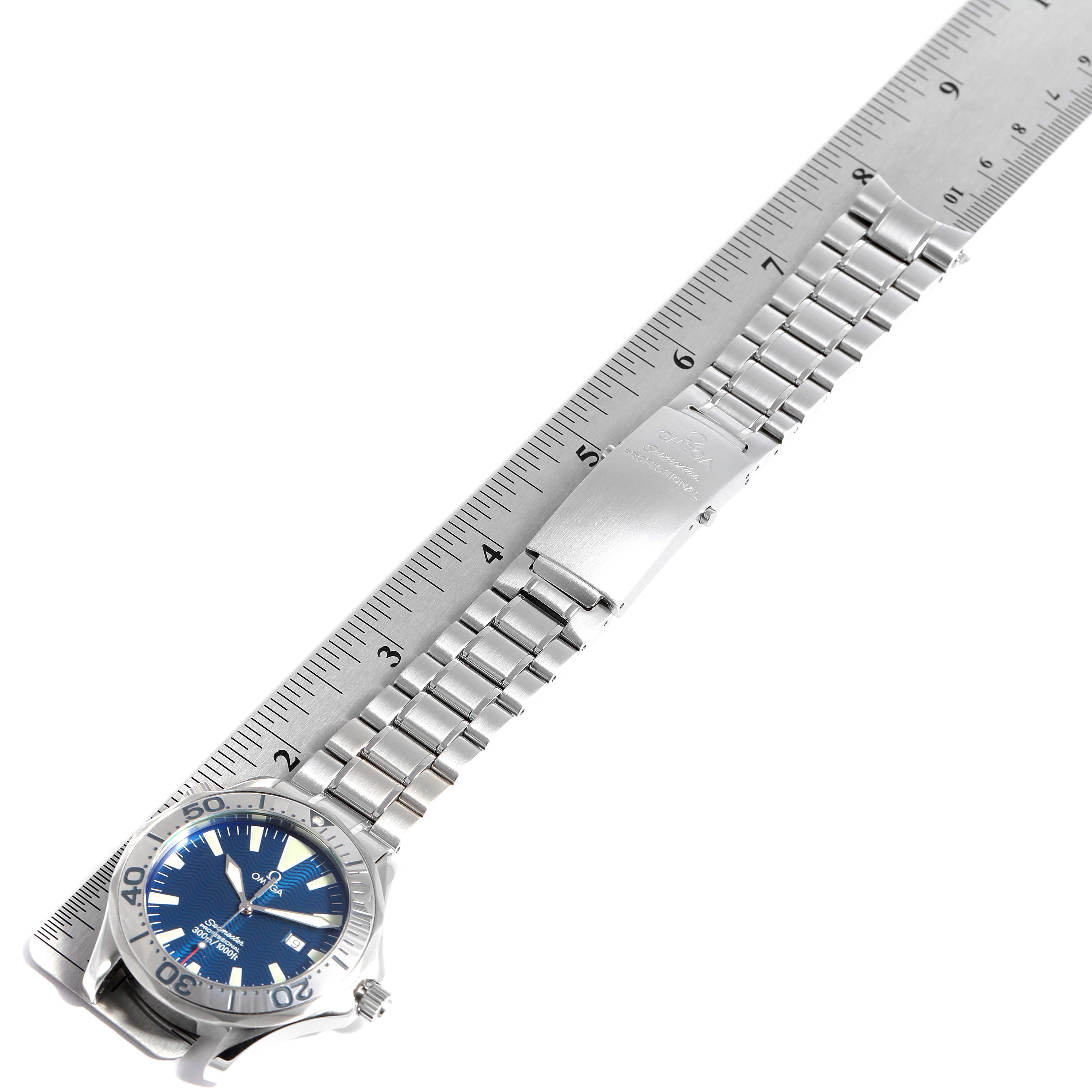 The Omega Seamaster 2255.80.00 Men
s Stainless Steel Blue Dial 2255.80.00 Men
s Stainless Steel Blue Dial watch is shown from a top-down angle with its bracelet extended next to a ruler for scale.