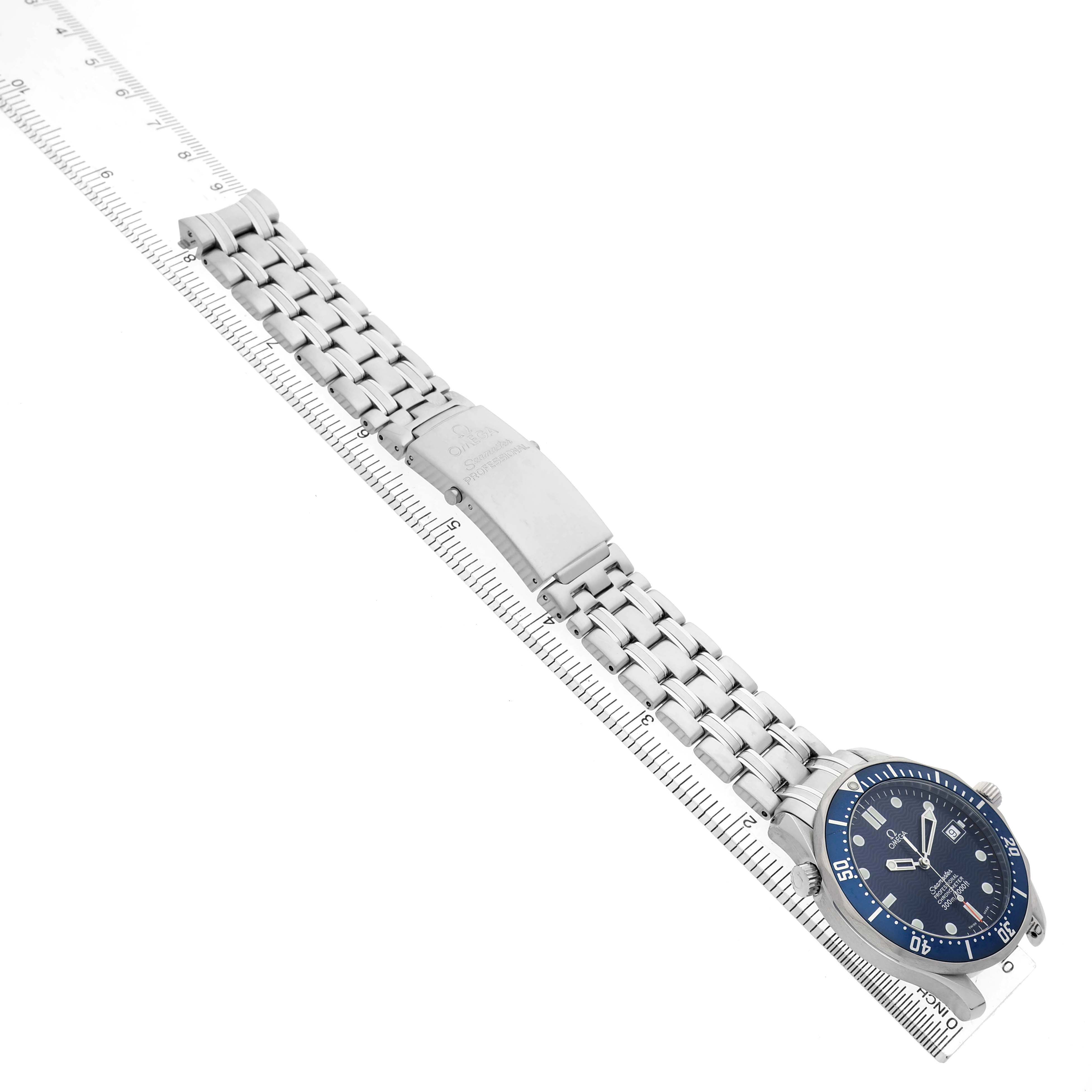 The Omega Seamaster 2531.80.00 Men's Stainless Steel Blue Dial watch is shown from a top view, displaying the face and bracelet beside a ruler.