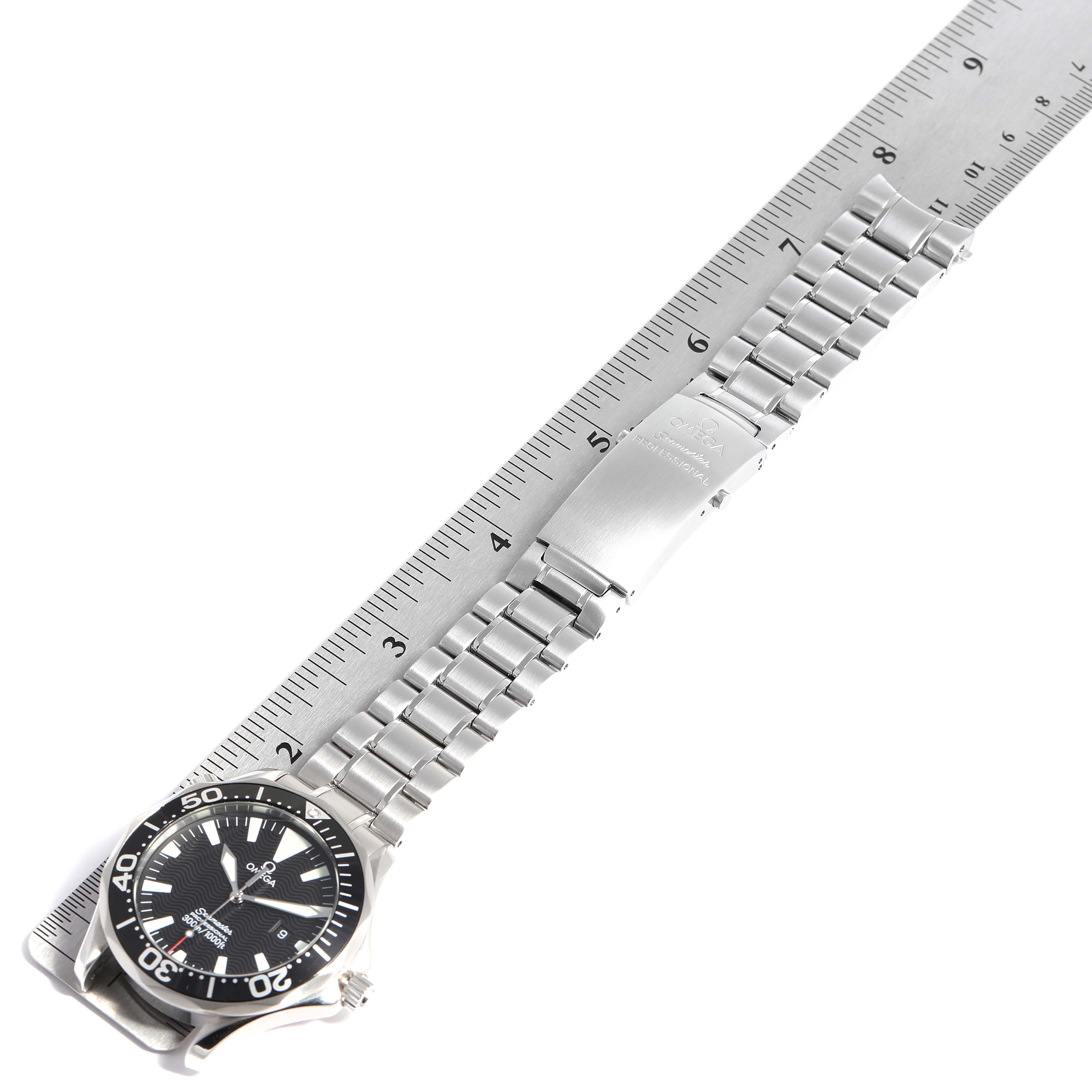 The image shows an Omega Seamaster 2264.50.00 Men
s Stainless Steel Black Dial 2264.50.00 Men
s Stainless Steel Black Dial watch laid face-up with its metal bracelet extended next to a ruler for measurement.