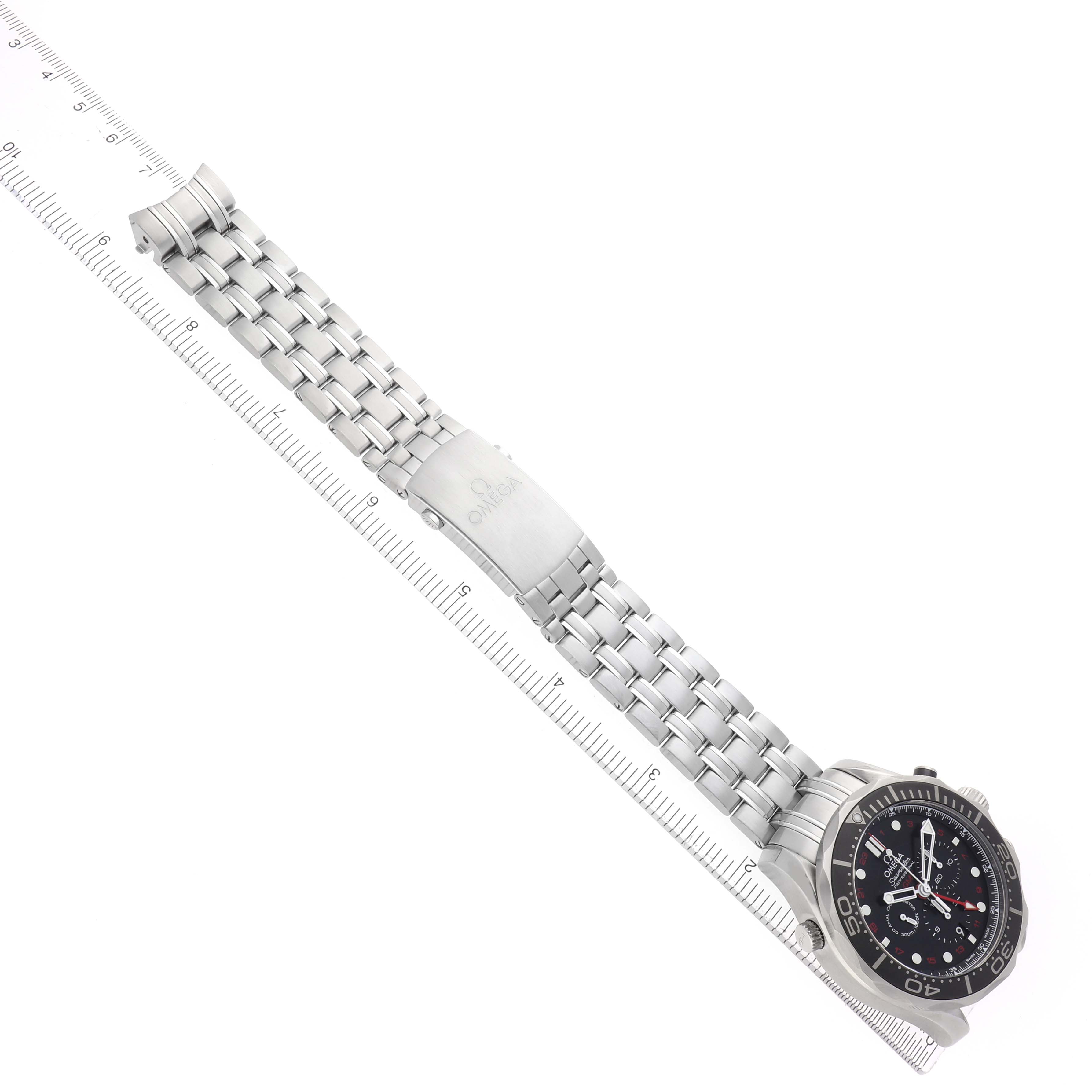 The Omega Seamaster 212.30.44.52.01.001 Men's Stainless Steel Black Dial is shown diagonally, highlighting the watch face and metal bracelet alongside a ruler.