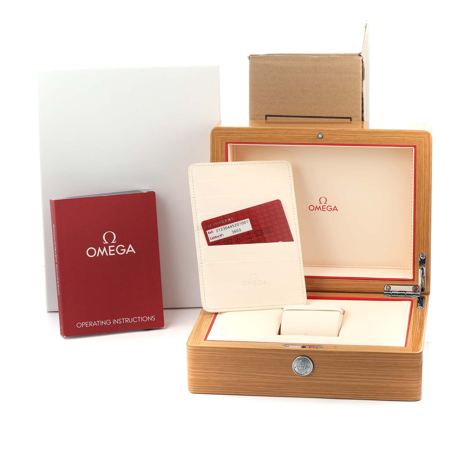 The image shows an open Omega Seamaster 212.30.44.52.01.001 Men's Stainless Steel Black Dial box, an instruction manual, and a cardholder with a red card.