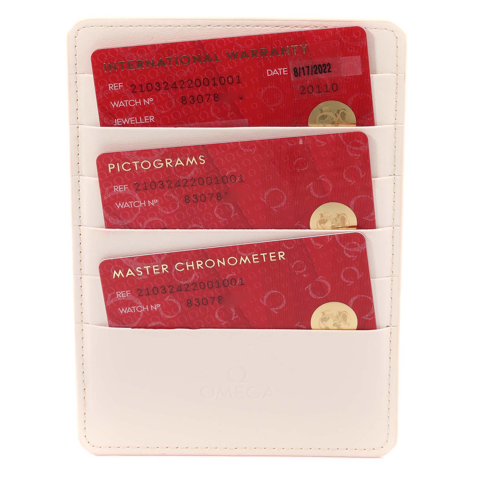 The image shows the International Warranty, Pictograms, and Master Chronometer cards for an Omega Seamaster 210.32.42.20.01.001 Men's Stainless Steel Black Dial 210.32.42.20.01.001 Men's Stainless Steel Black Dial watch, stored in a white cardholder.