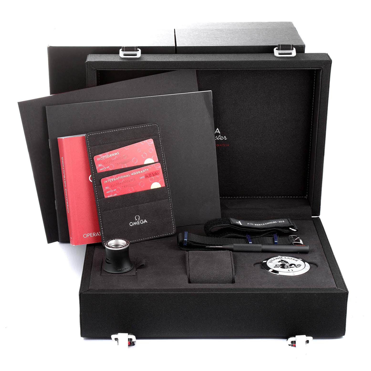 The image shows the packaging, warranty cards, manual, straps, and accessories of the Omega Speedmaster 311.30.42.30.01.005 Men
s Stainless Steel Black Dial 311.30.42.30.01.005 Men
s Stainless Steel Black Dial watch.