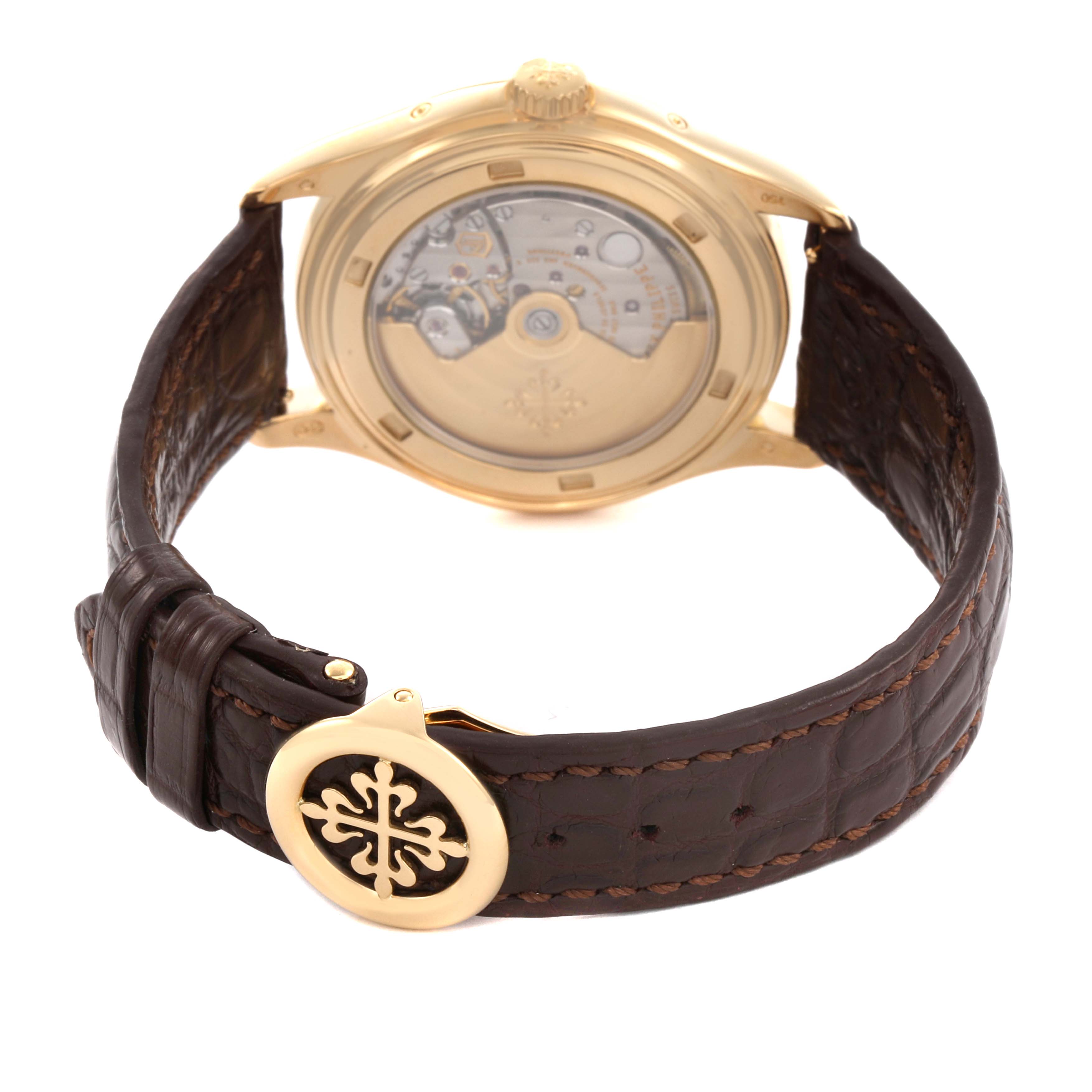 The image shows the back view of a Patek Philippe Complications 5146J-001 Men's Yellow Gold Beige Dial watch, highlighting its leather strap and transparent case back.