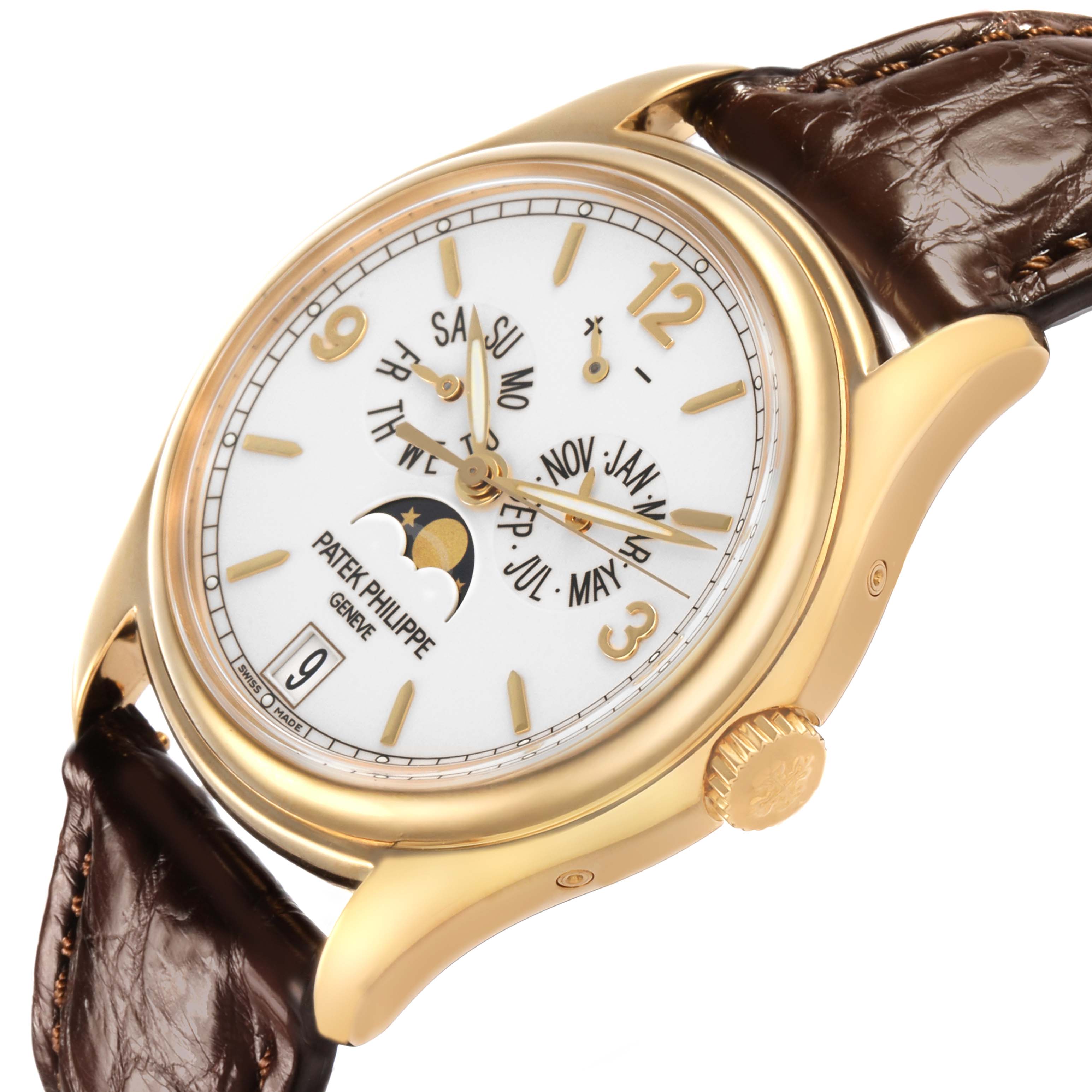 The Patek Philippe Complications 5146J-001 Men's Yellow Gold Beige Dial watch is shown at a slight angle, highlighting the face, moon phase, and gold case with a leather strap.