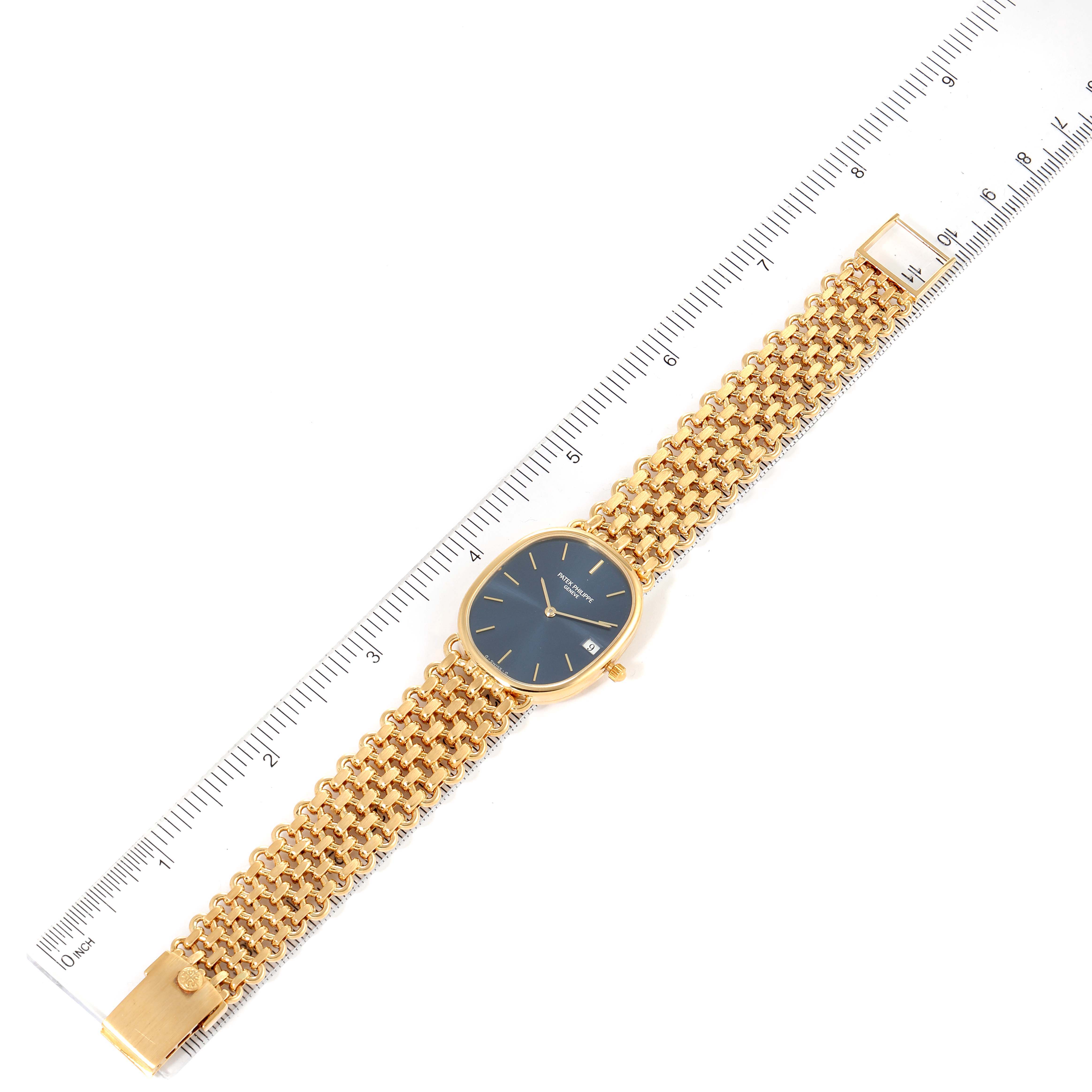 The Patek Philippe Golden Ellipse 3788 Women's Yellow Gold Blue Dial 3788 Women's Yellow Gold Blue Dial watch is shown from a top-down angle with a ruler for scale.