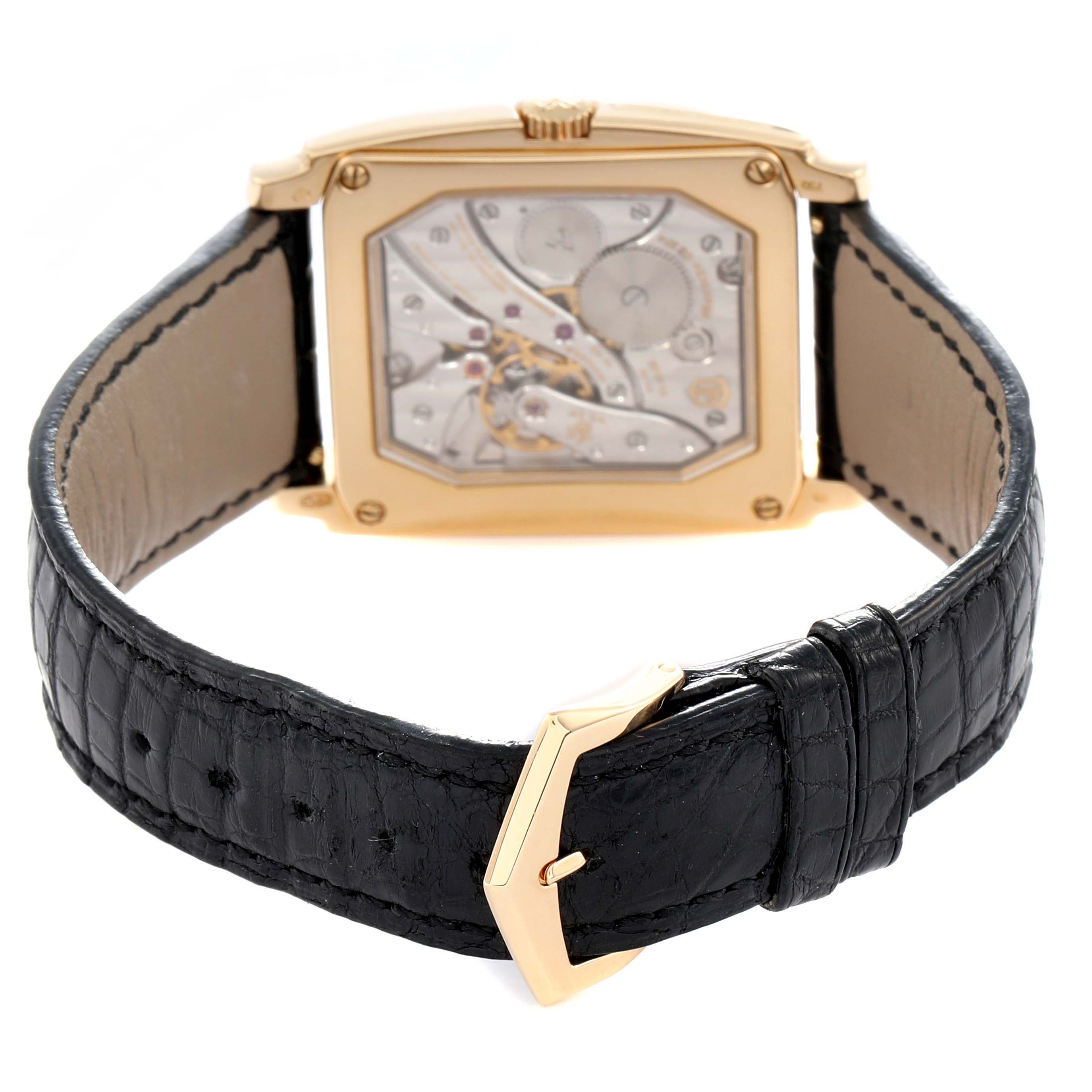 The Patek Philippe Gondolo 5124 Men
s Yellow Gold Silver Dial watch is shown from a rear angle, highlighting the movement and black leather strap with a gold buckle.