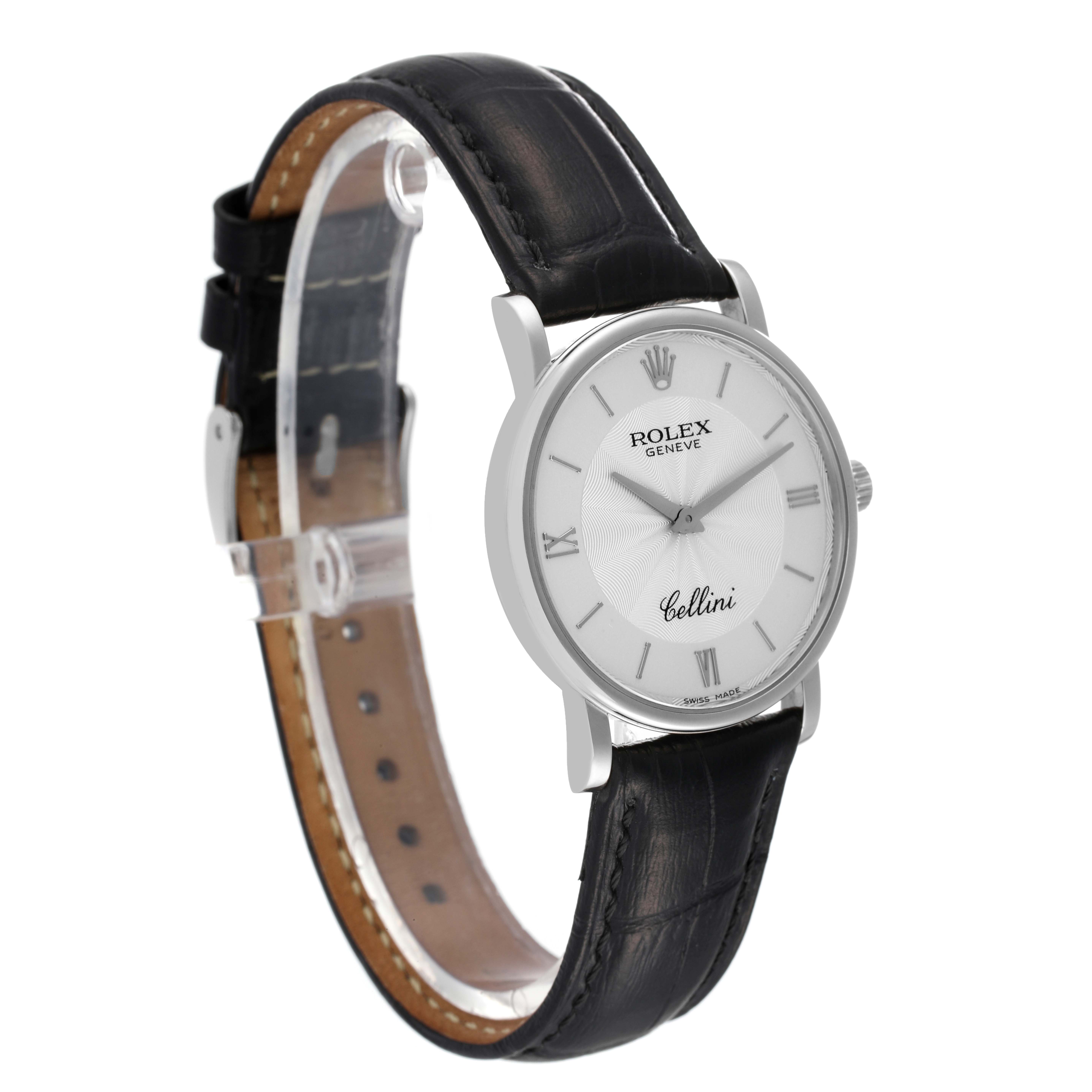 The image shows a Rolex Cellini 5115 Men
s White Gold Silver Dial 5115 Men
s White Gold Silver Dial watch at an angled view, highlighting its black strap, white dial, and silver casing.