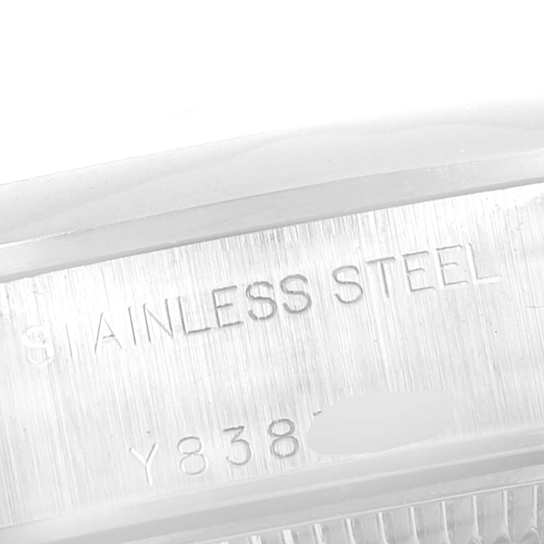 The image shows a close-up of the inner case engraved with "Stainless Steel" and partial numbers of a Rolex Date 79160 Women's Stainless Steel Blue Dial 79160 Women's Stainless Steel Blue Dial model watch.