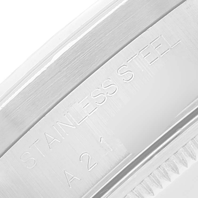 The image shows a close-up view of the stainless steel casing of a Rolex Date 15210 Men's Stainless Steel Blue Dial 15210 Men's Stainless Steel Blue Dial model watch.