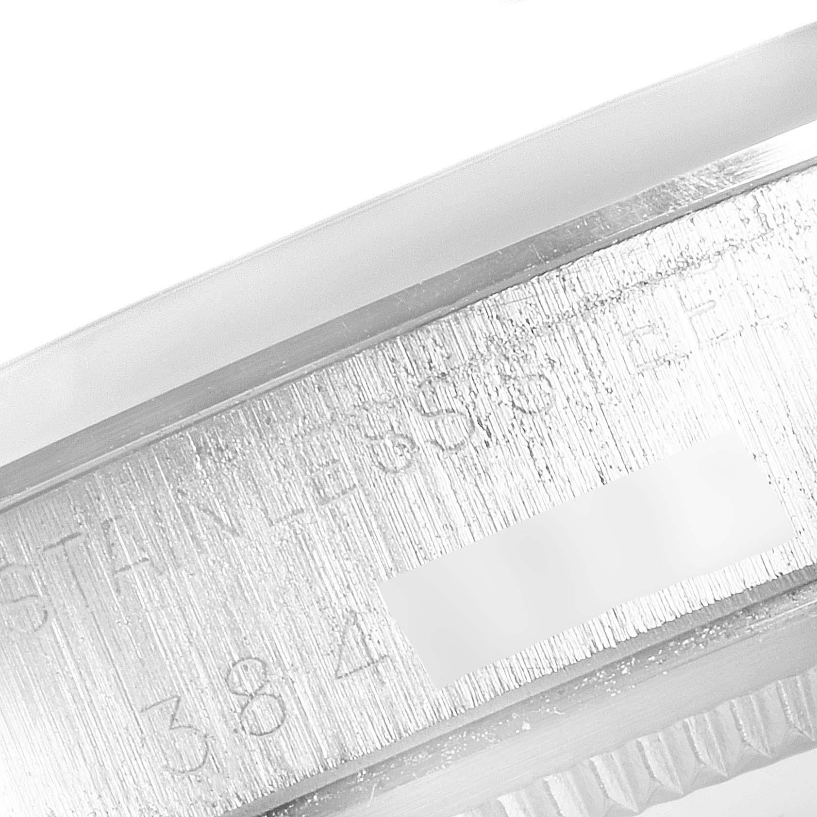 This image shows a close-up view of the Rolex Date 1500 Men's Stainless Steel Silver Dial 1500 Men's Stainless Steel Silver Dial model's case side, highlighting its stainless steel construction and serial number.