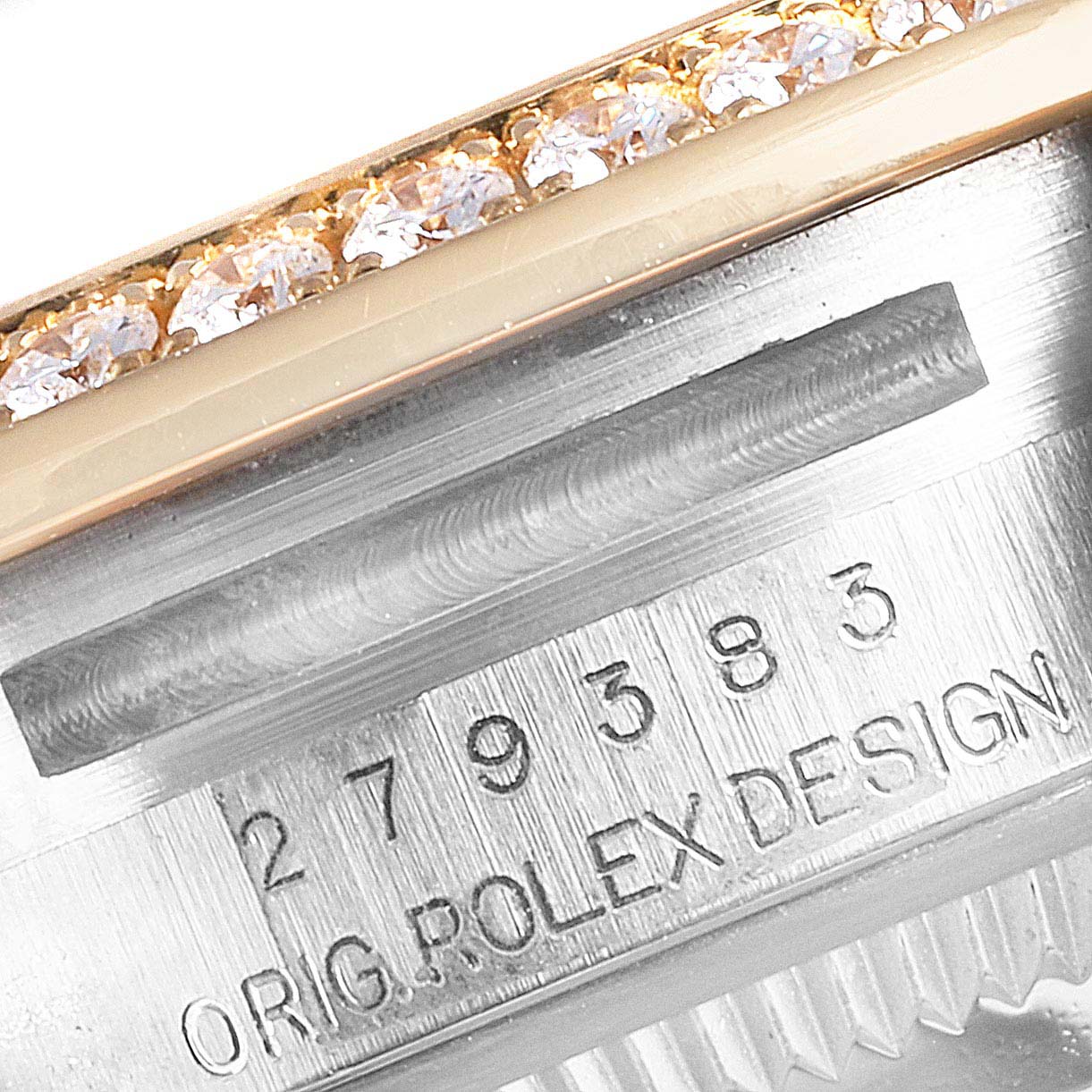 This close-up image of a Rolex Datejust 279383 Women
s Steel and Gold (two tone) Champagne Dial 279383 Women
s Steel and Gold (two tone) Champagne Dial watch shows part of the serial number engraving and the diamond-set bezel.