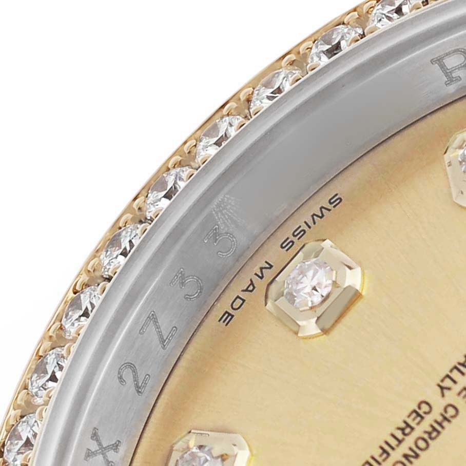 The image shows a close-up of the bezel and part of the dial of a Rolex Datejust 116243 Men's Steel and Gold (two tone) Champagne Dial, featuring diamond details.