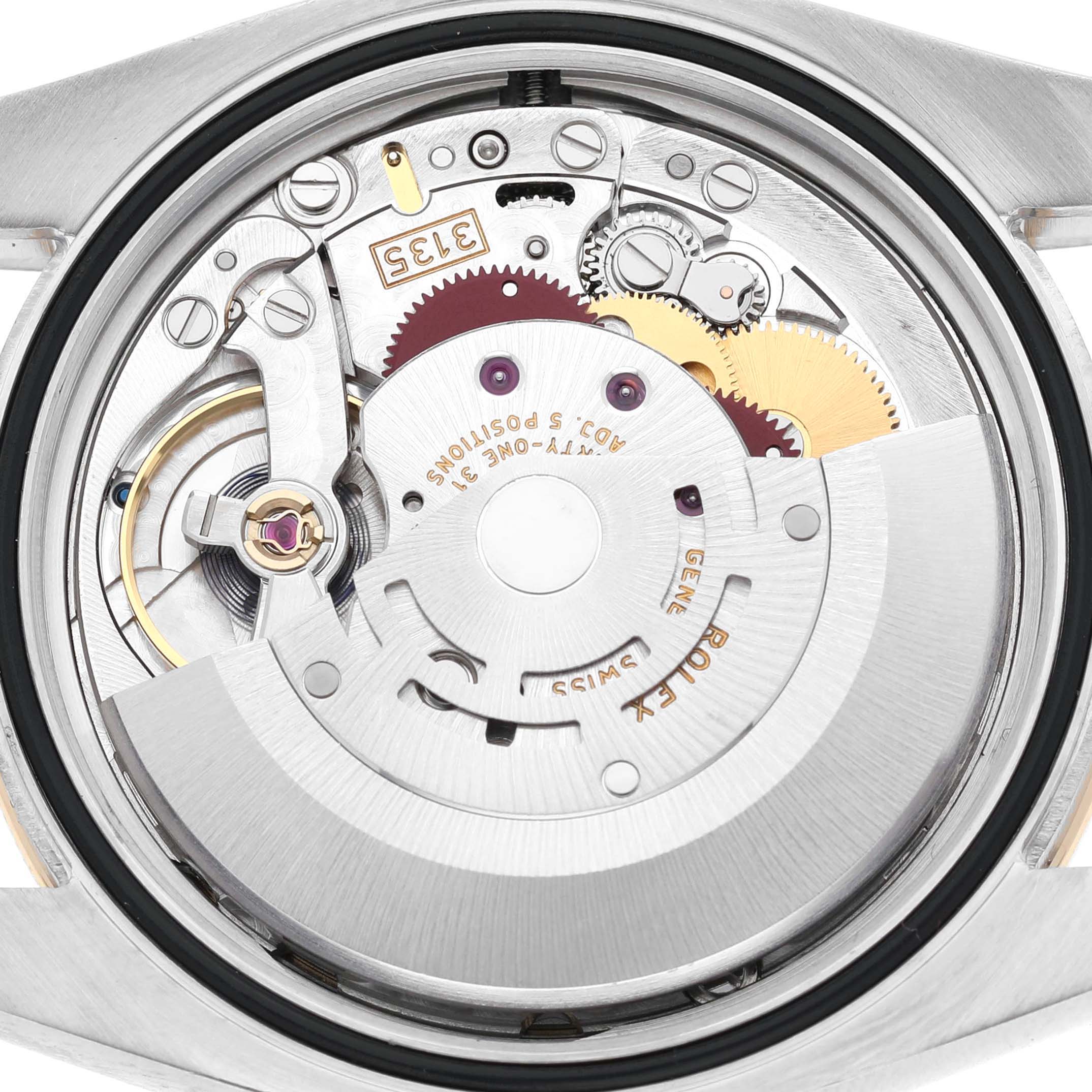 The image shows the movement of a Rolex Datejust 116243 Men's Steel and Gold (two tone) Champagne Dial watch from a direct view, highlighting its mechanical components and engravings.