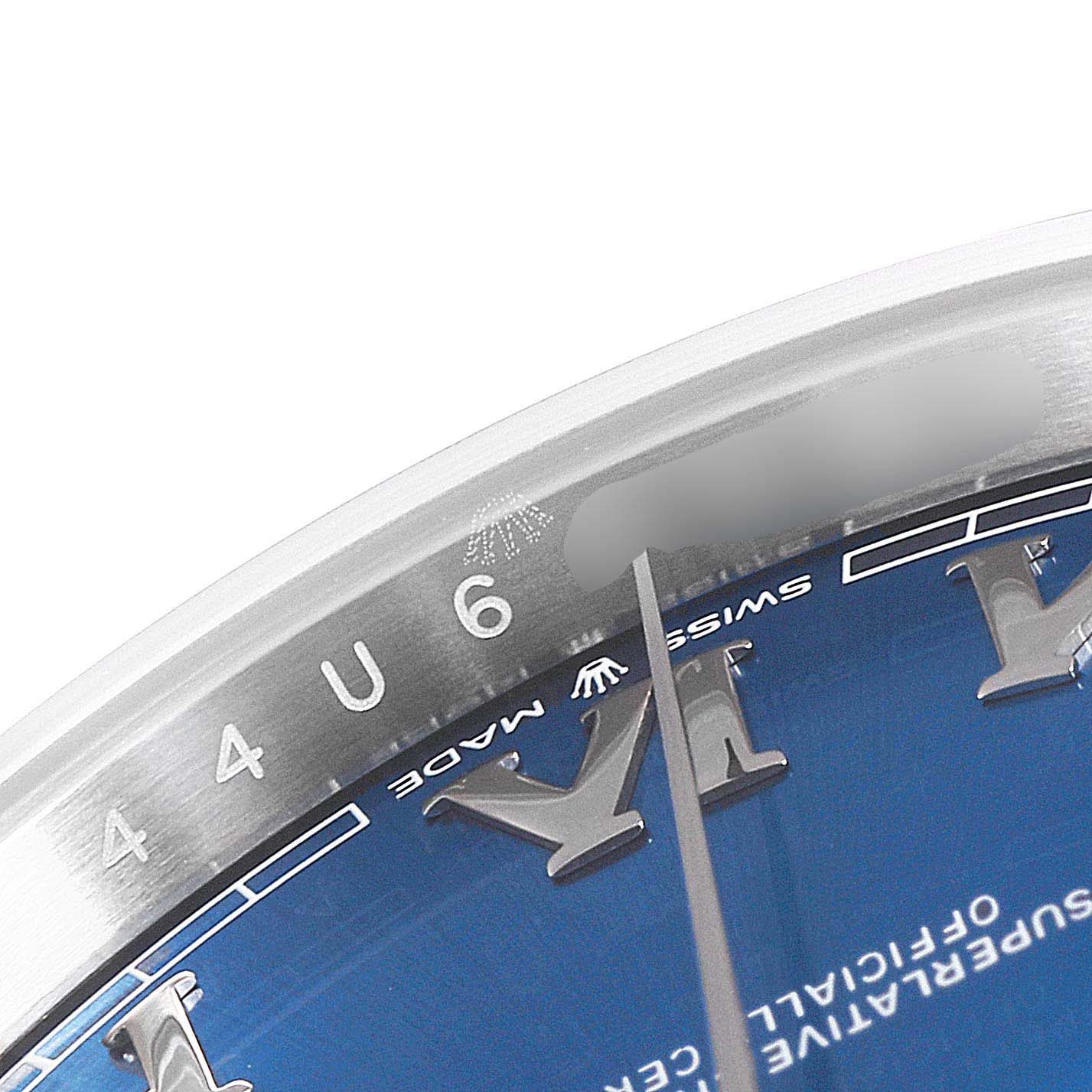 The image shows a close-up of the Rolex Datejust 41 126300 Men
s Stainless Steel Blue Dial 126300 Men
s Stainless Steel Blue Dial model, focusing on the edge of the dial and part of the case, highlighting the Roman numeral hour markers.