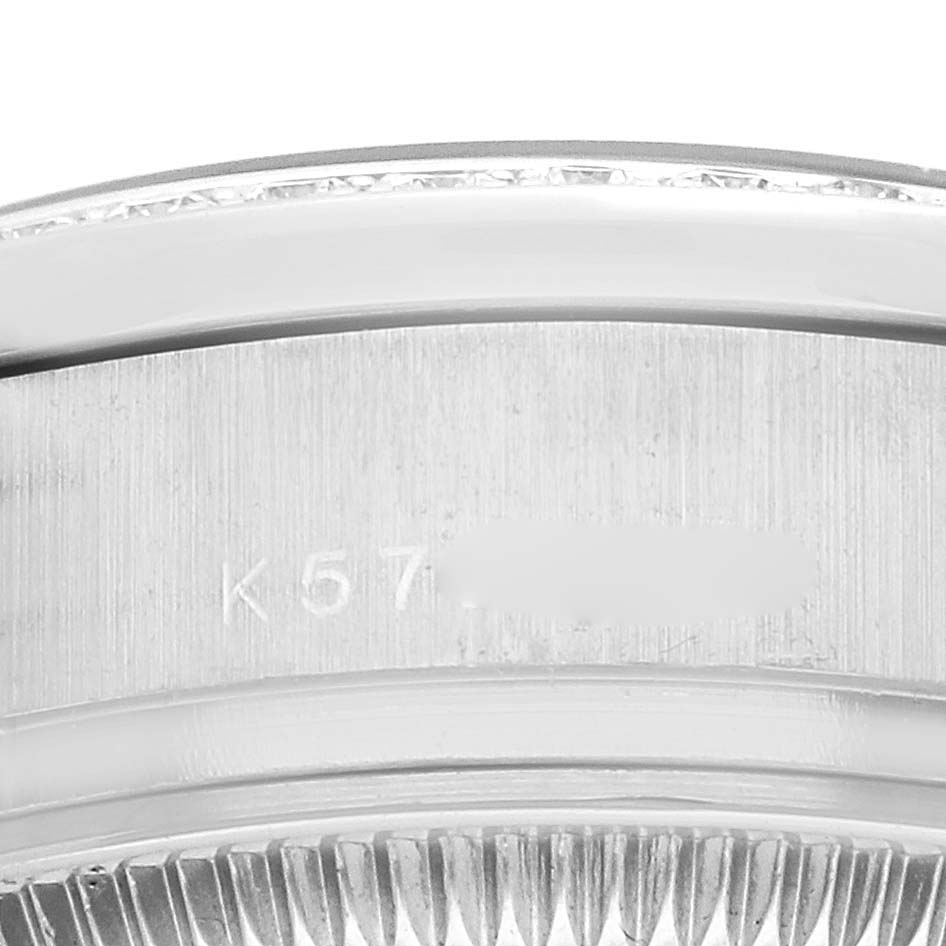 The image shows a close-up of the side and bezel of a Rolex President 179159 Women
s White Gold Silver Dial watch, highlighting the serial engraving.