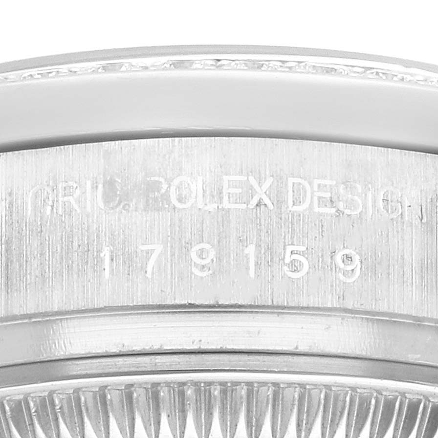 The image shows a close-up of the Rolex President 179159 Women
s White Gold Silver Dial model case, focusing on the serial engraving.