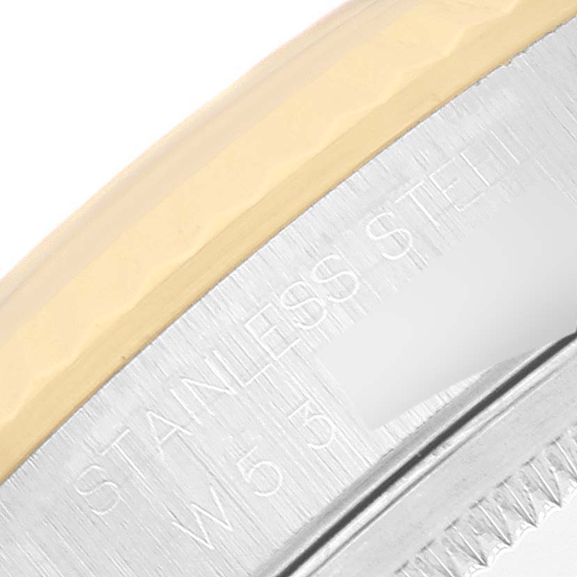 The image shows a close-up of the stainless steel and gold edge of a Rolex Datejust 16233 Men's Steel and Gold (two tone) White Dial 16233 Men's Steel and Gold (two tone) White Dial watch, including part of its engraved text.