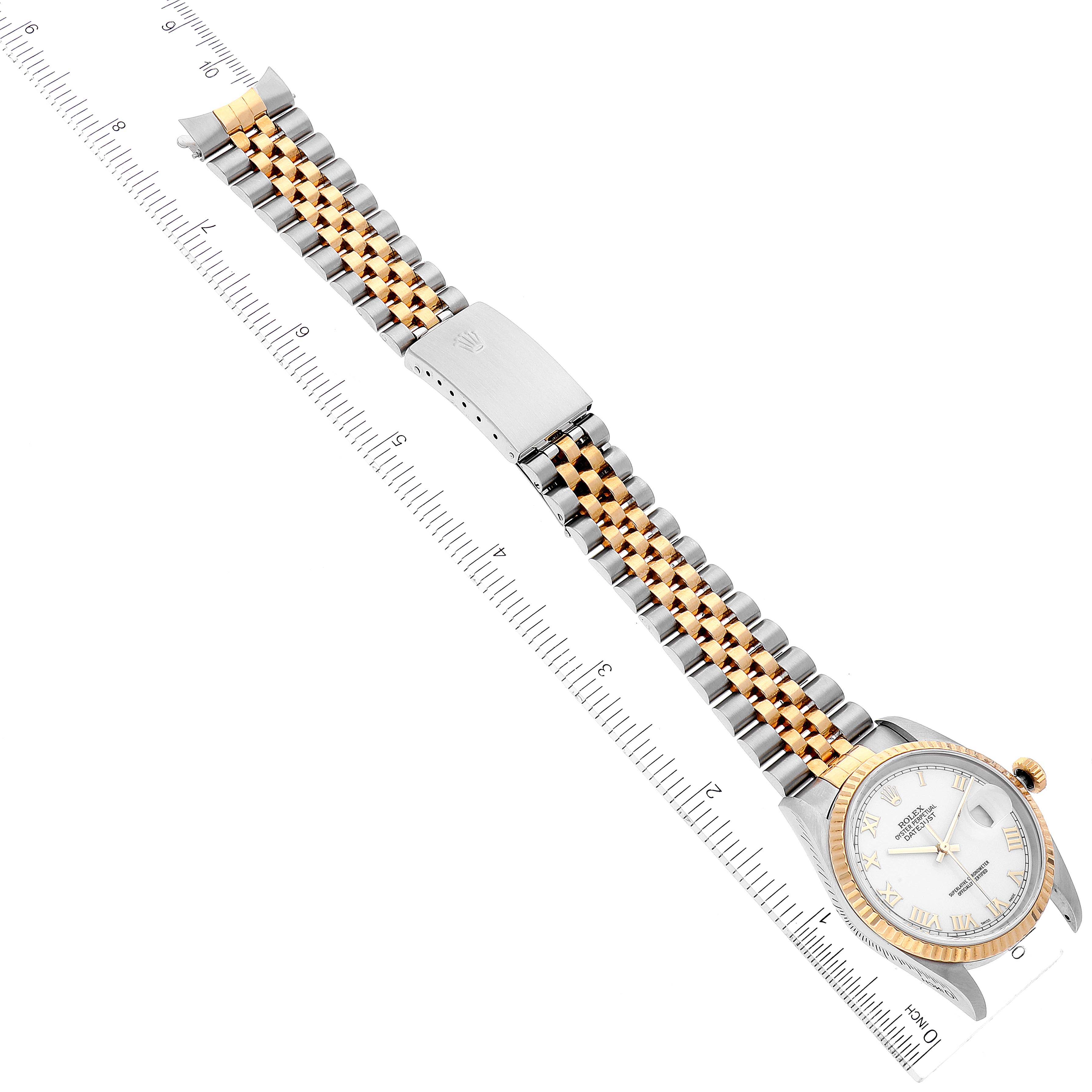 The image shows a Rolex Datejust 16233 Men's Steel and Gold (two tone) White Dial 16233 Men's Steel and Gold (two tone) White Dial watch positioned flat, displaying the face, bezel, and two-tone bracelet with a clasp beside a ruler.
